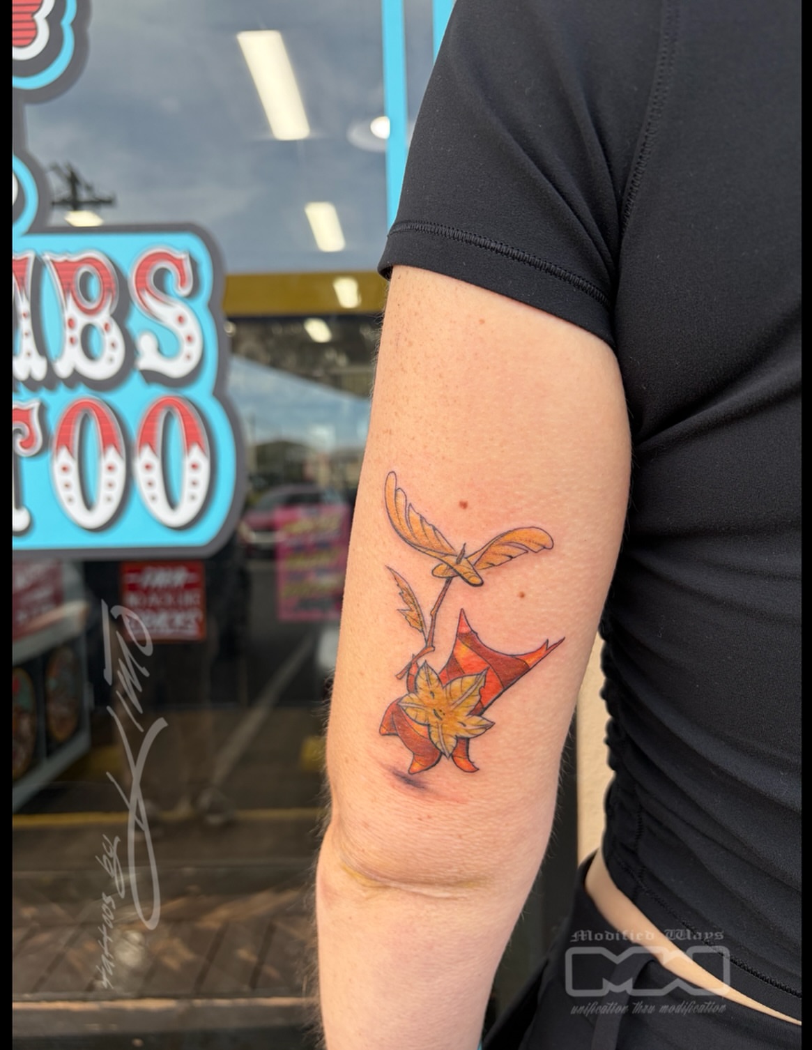 Bird and autumn leaves geometric tattoo on the forearm by Kansas City tattoo artist