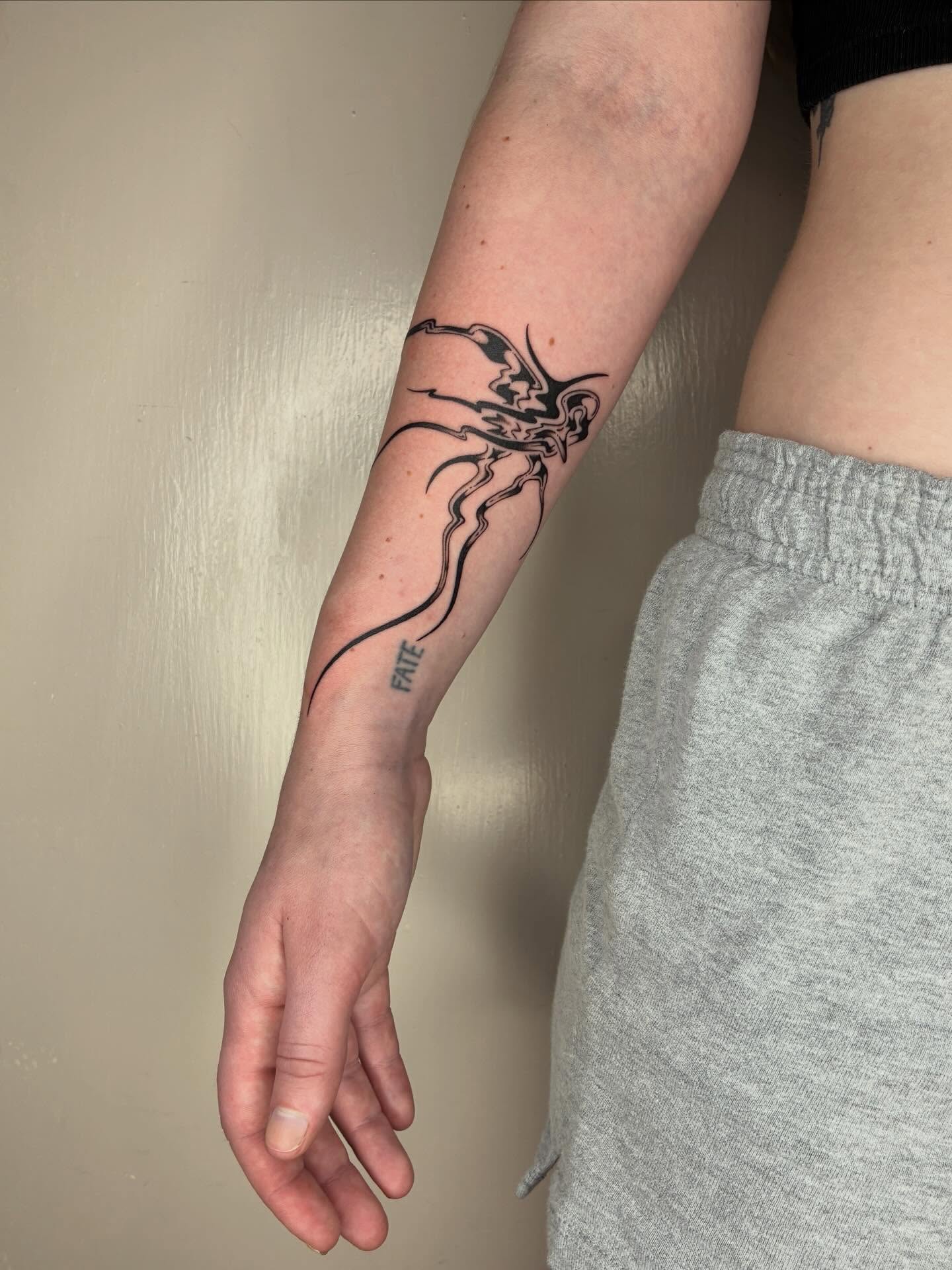 Abstract creature black and grey tattoo on the forearm by Steven Sessler, San Francisco, California