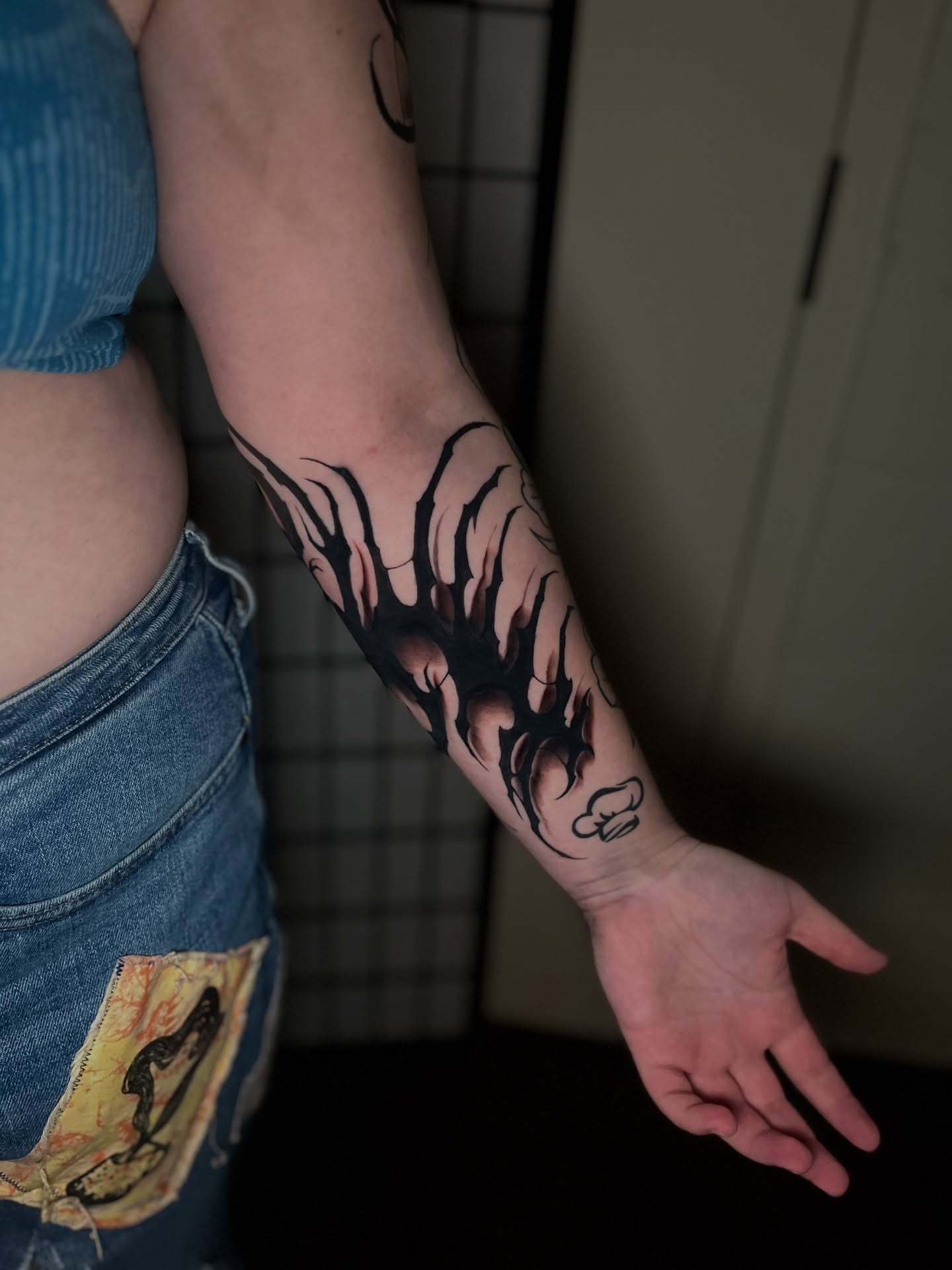 Flames black and grey tattoo on the forearm by Mant