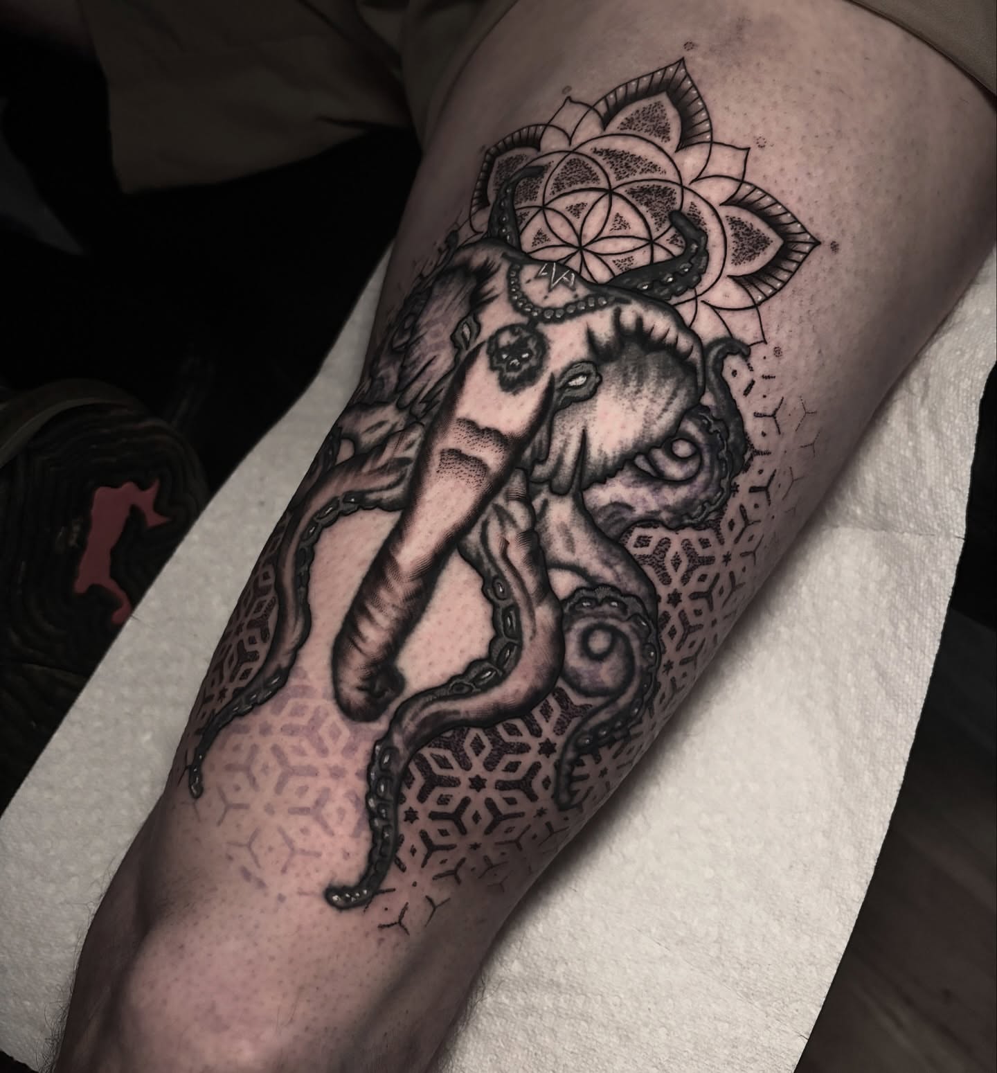 Octopus geometric tattoo on the thigh by Ashley Denise