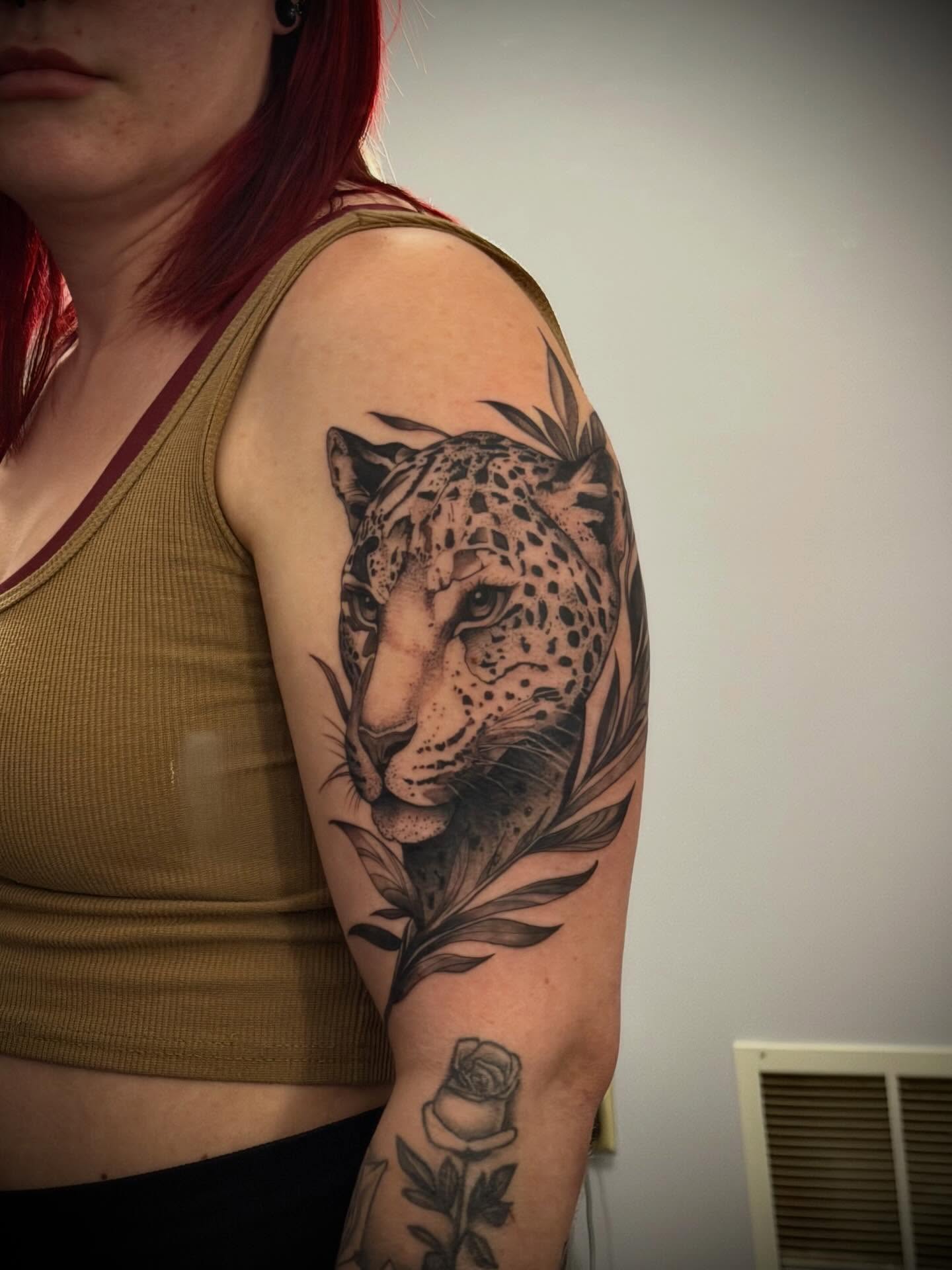 Snow leopard realism tattoo on the upper arm by Kbtattz