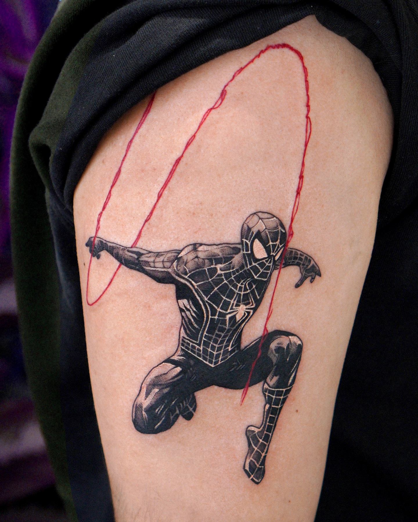 Spider-man black and grey tattoo on the upper arm by Eden