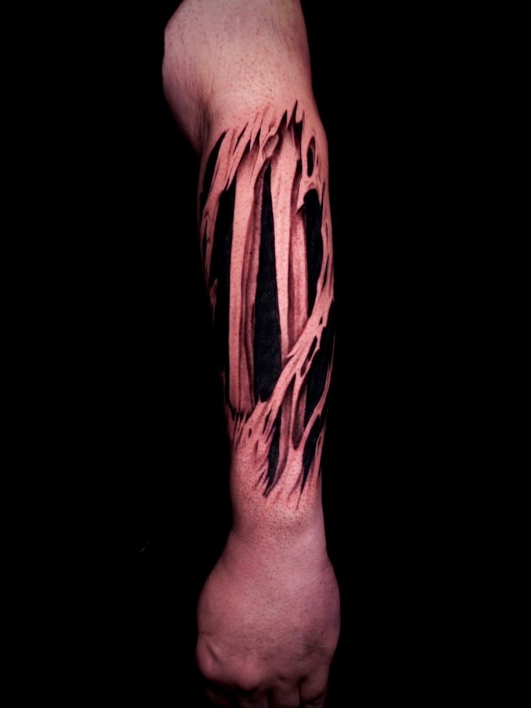 Tear realism tattoo on the forearm by Greg Petrali