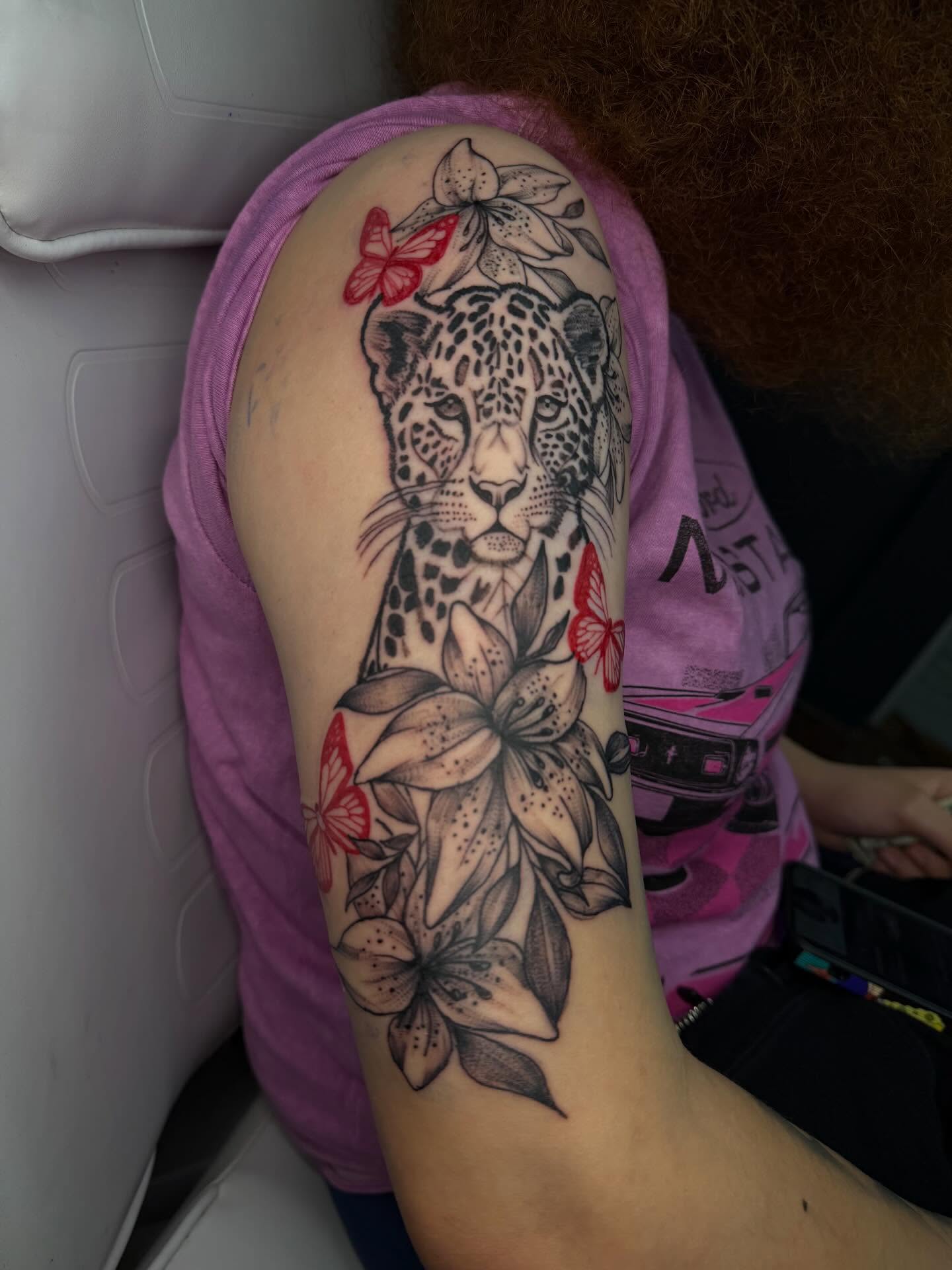 Leopard and lilies realism tattoo on the forearm by addicted222inkk🎨
