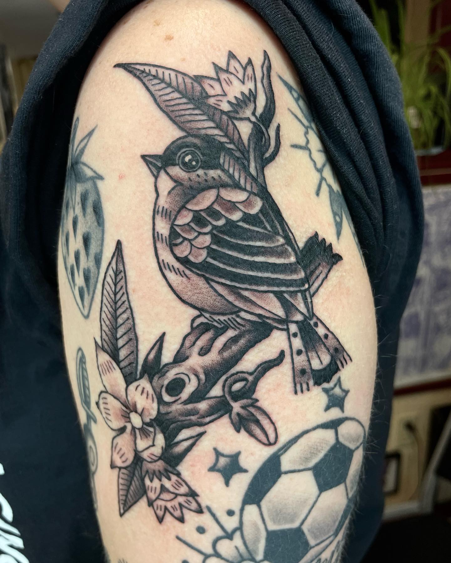 Bird and flowers American traditional tattoo on the shoulder by Gerald Bellmore