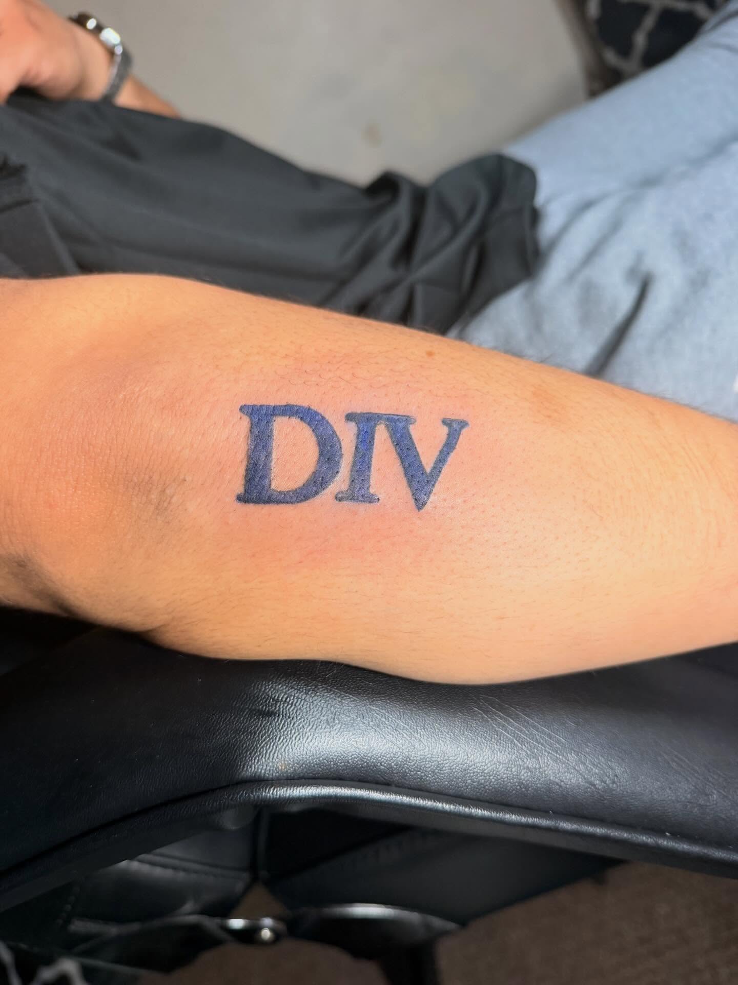DIV lettering script tattoo on the forearm by @bloodline__legacy