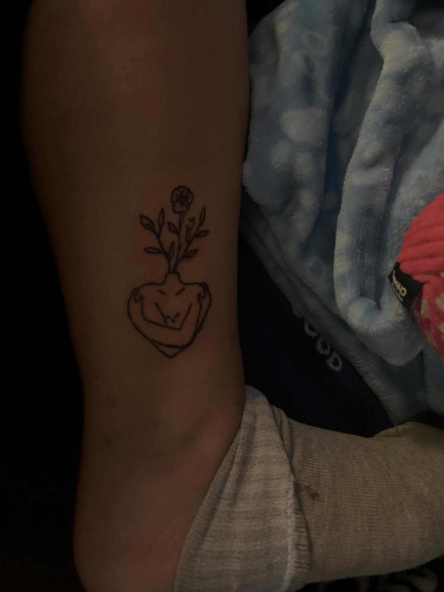 Flower in heart minimalist tattoo on the forearm by @bloodline__legacy