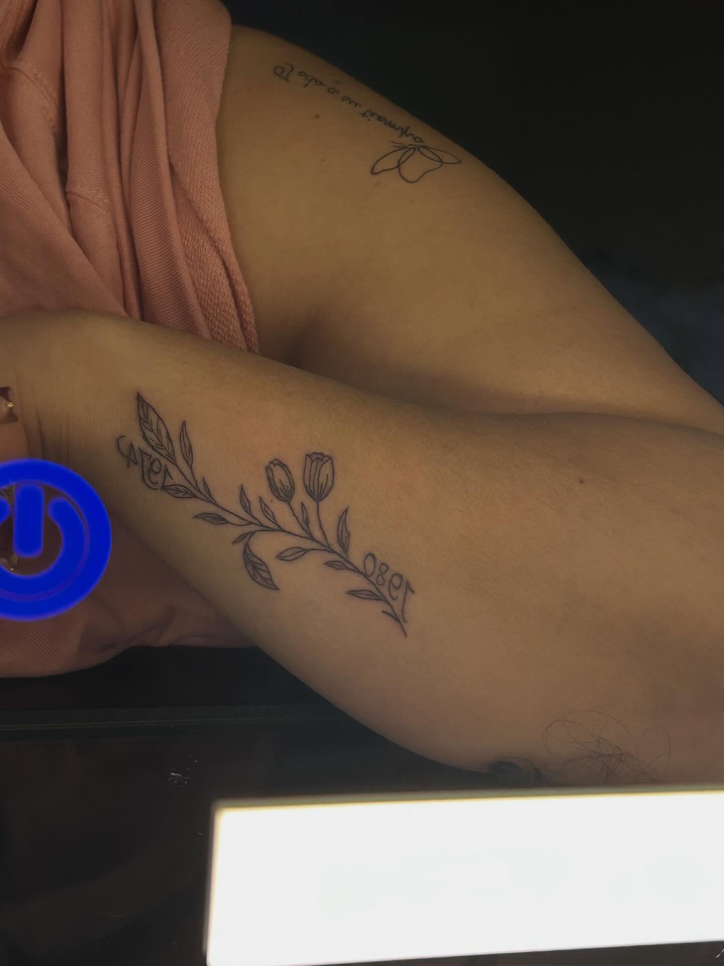 Flower branch fine line tattoo on the forearm by @bloodline__legacy