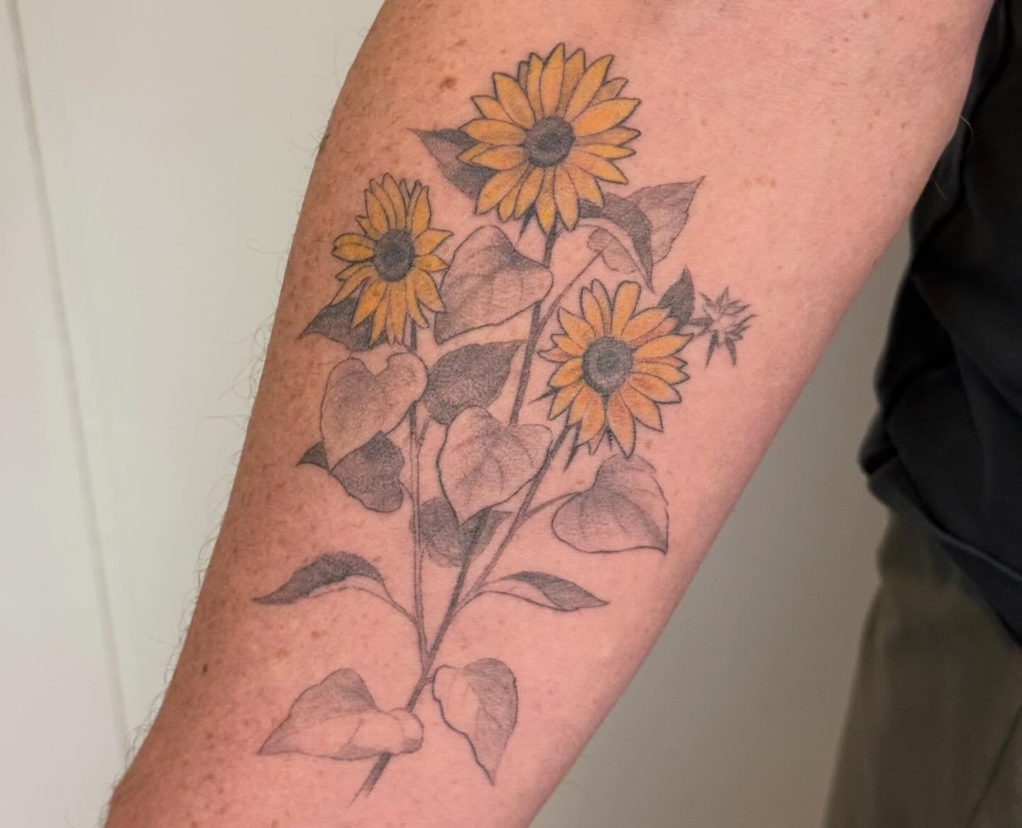 Sunflowers black and grey tattoo on the forearm by Justin Turkus