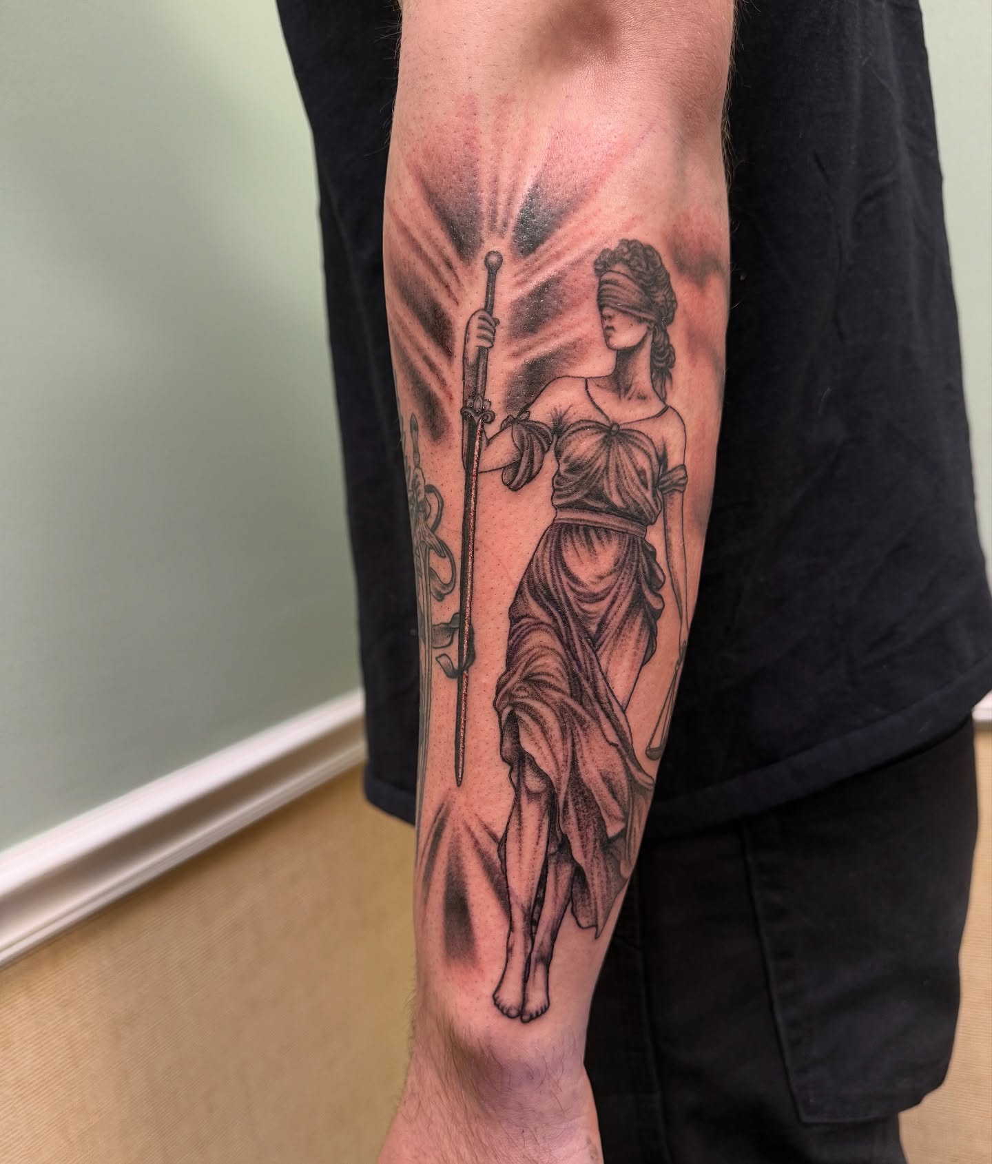 Statue of lady justice black and grey tattoo on the forearm by Eva, Matawan, New Jersey