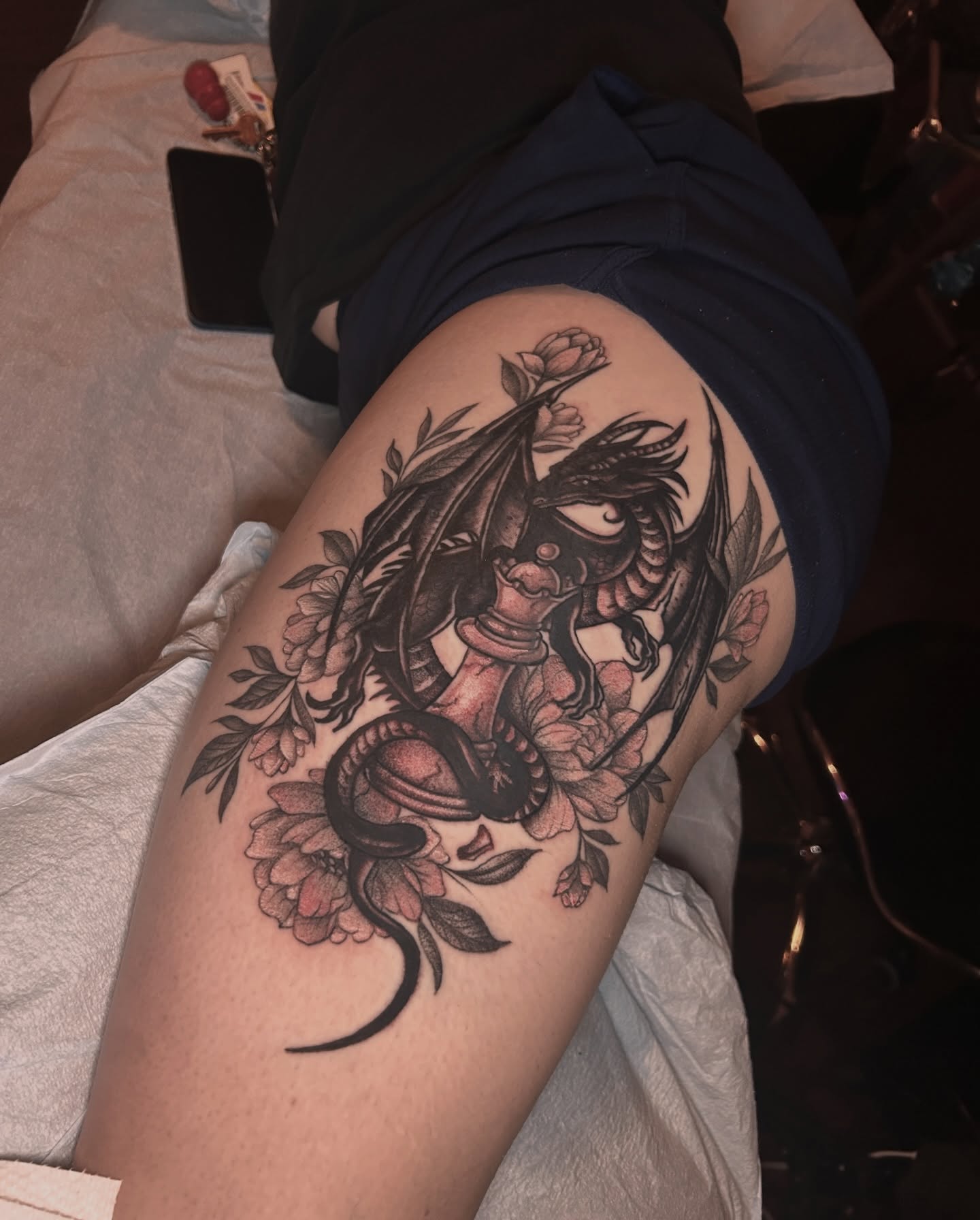 Dragon and flowers realism tattoo on the thigh by Kat McCoy Guidera, Nashville, Tennessee