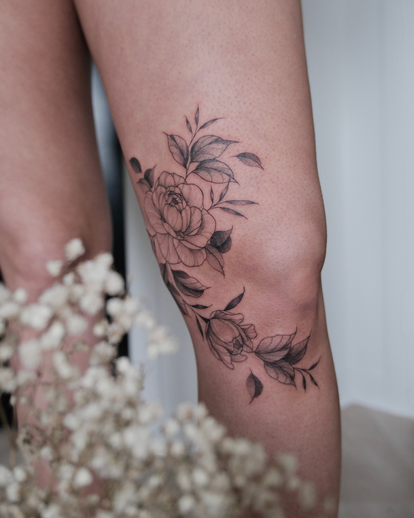 Peony flowers black and grey tattoo on the thigh by Haley Sayers
