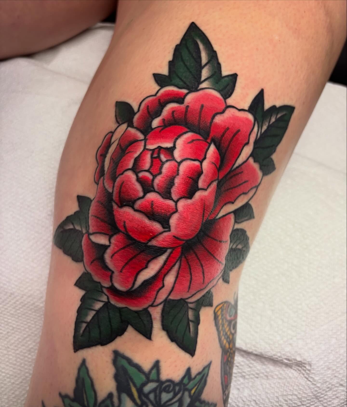 Red rose American traditional tattoo on the forearm by Chris Dufresne