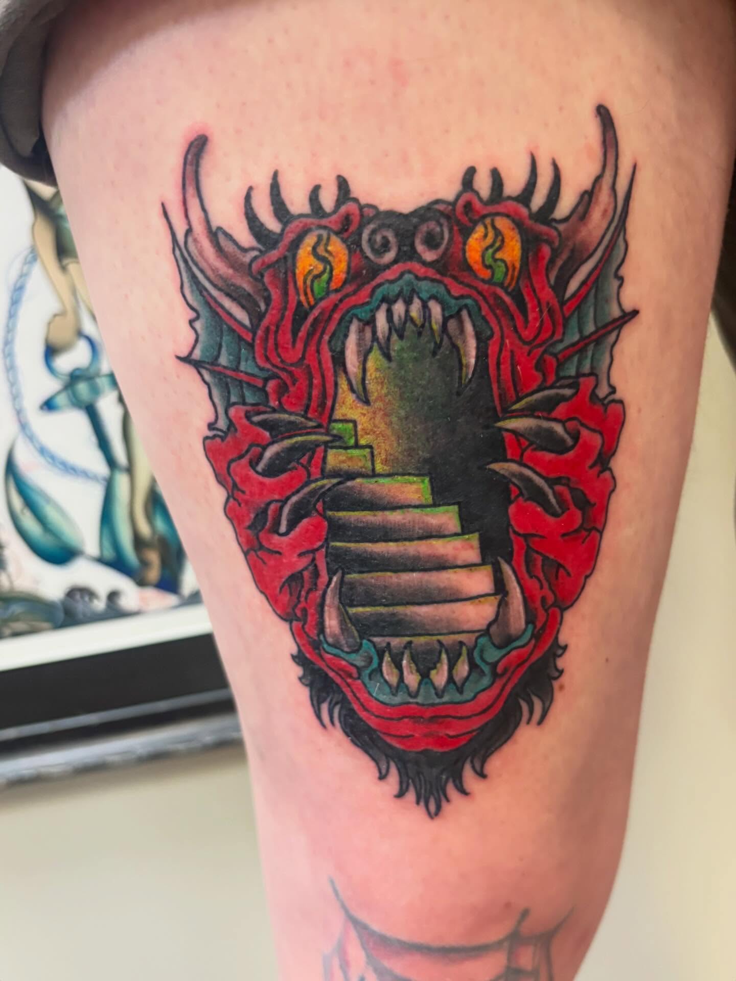 Staircase through dragon mouth American traditional tattoo on the thigh by Gabby, Kansas City, Missouri
