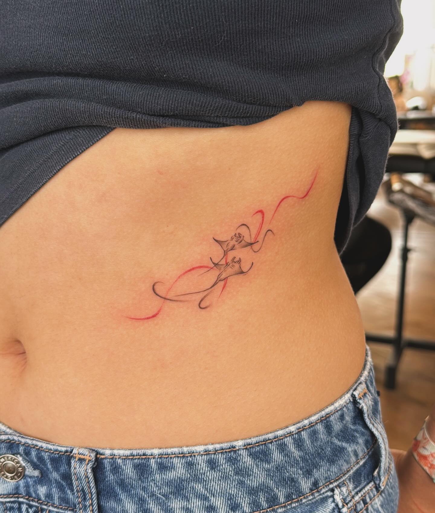 Koi fish fine line tattoo on the torso by Ethan