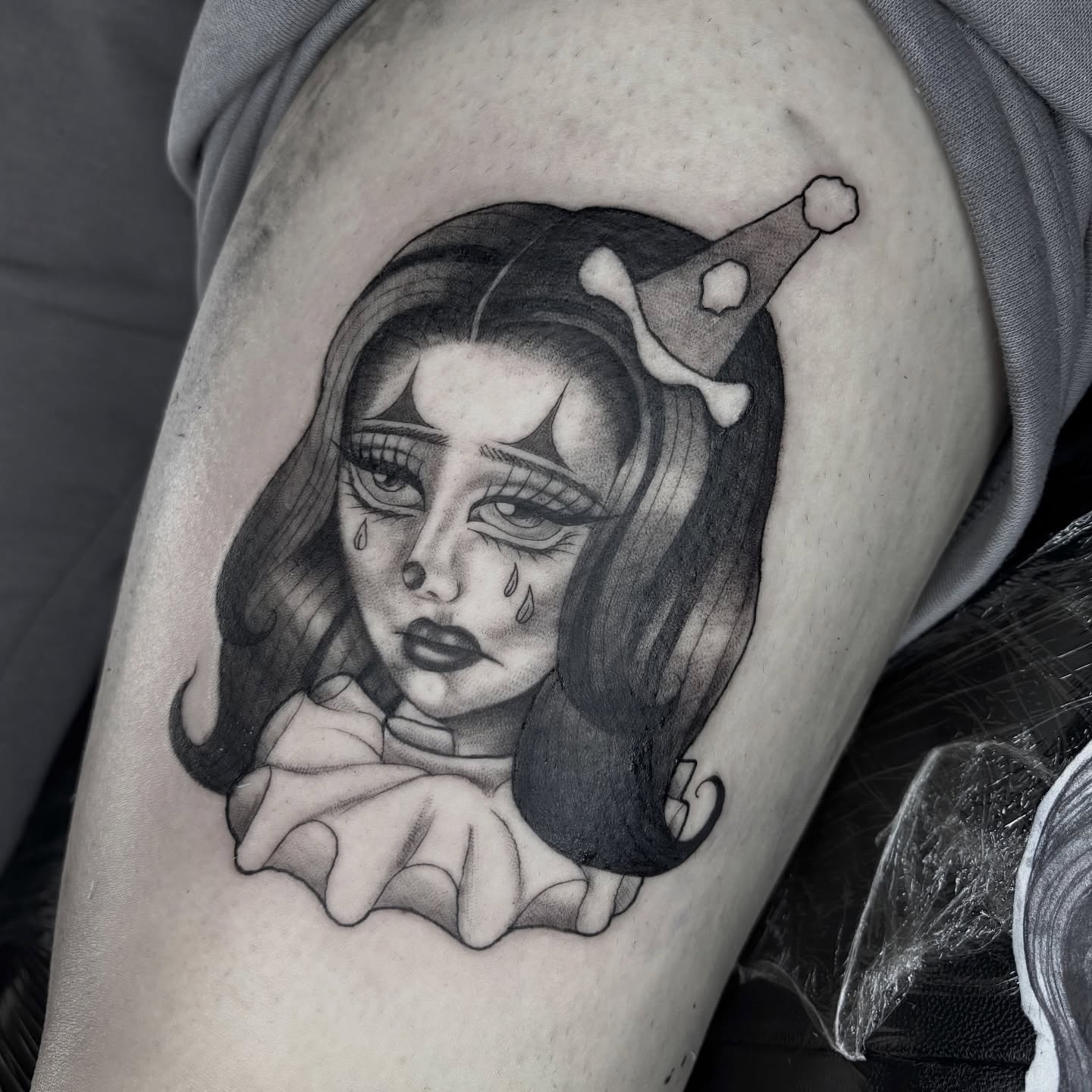 Woman with tears realism tattoo on the thigh by Weho Tattoo Artist Lupe