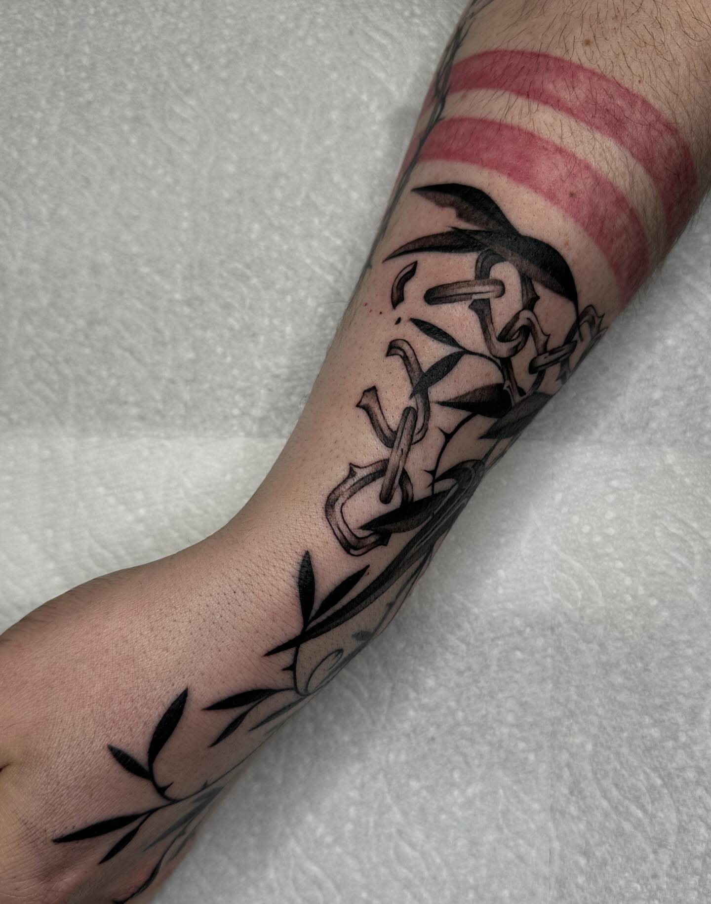 Anchor and chain black and grey tattoo on the forearm by Aleksandra