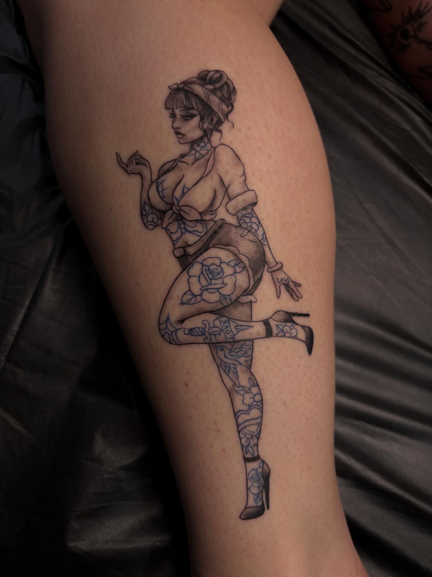 Pin-up girl black and grey tattoo on the thigh by Alexandria