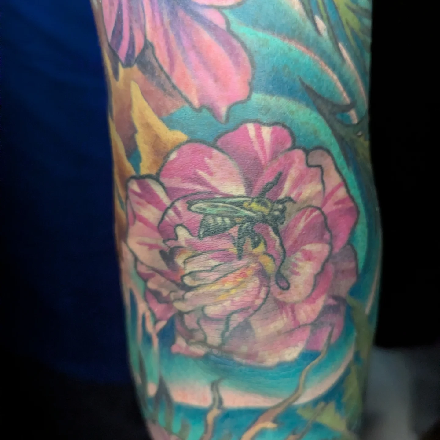 Flower and bee new school tattoo on the forearm by Devon Greig