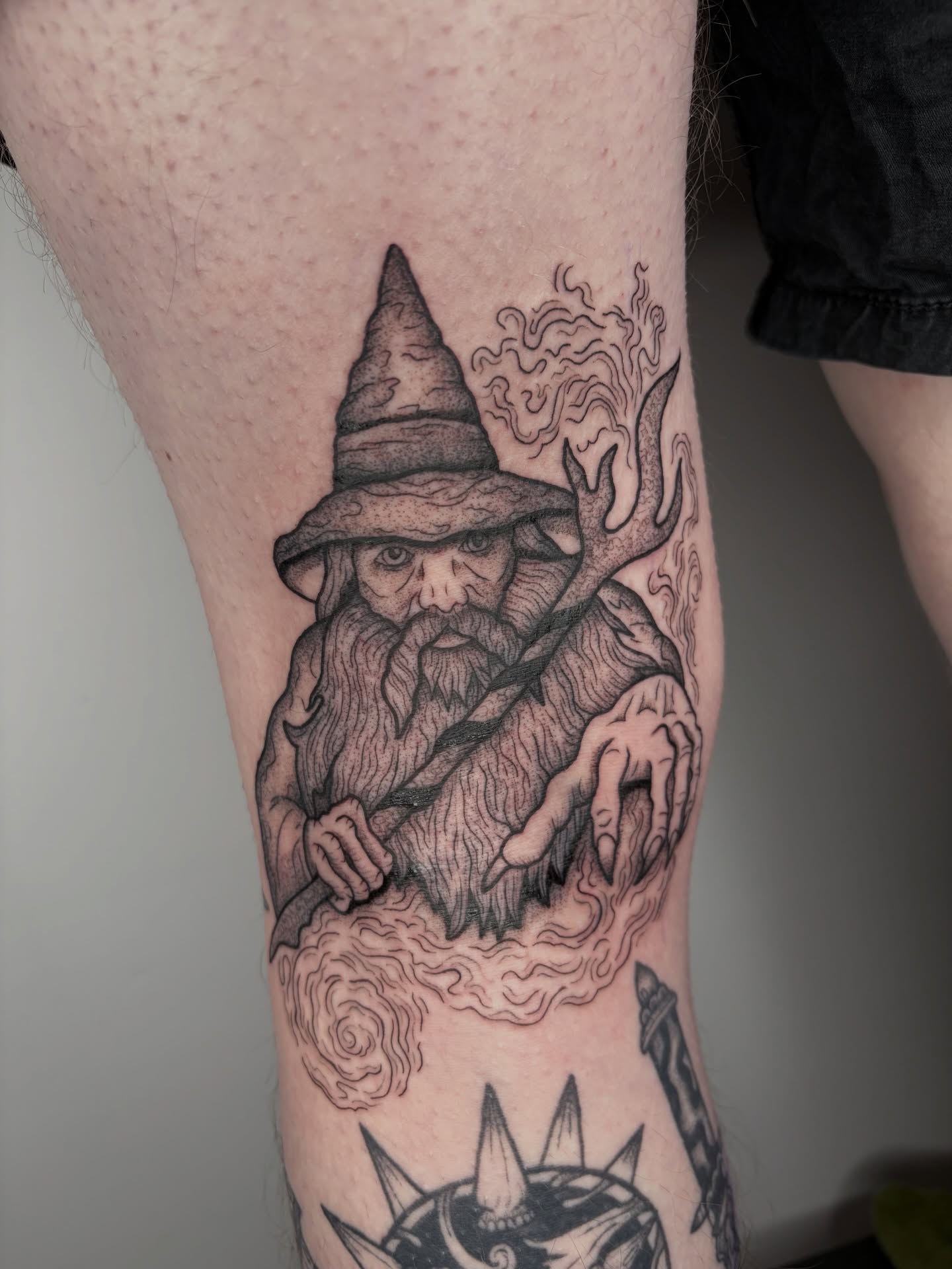 Wizard black and grey tattoo on the forearm by Poppy Olivia Deards