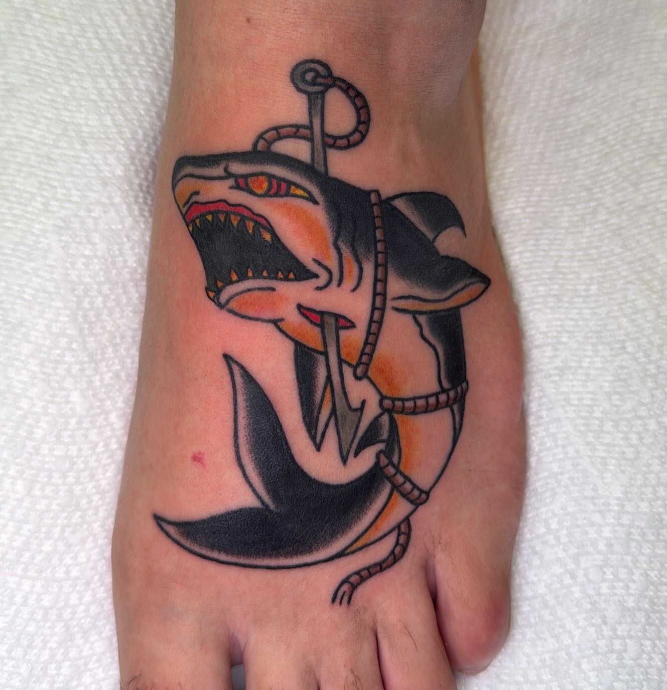 Shark and anchor American traditional tattoo on the foot by Zach Eden
