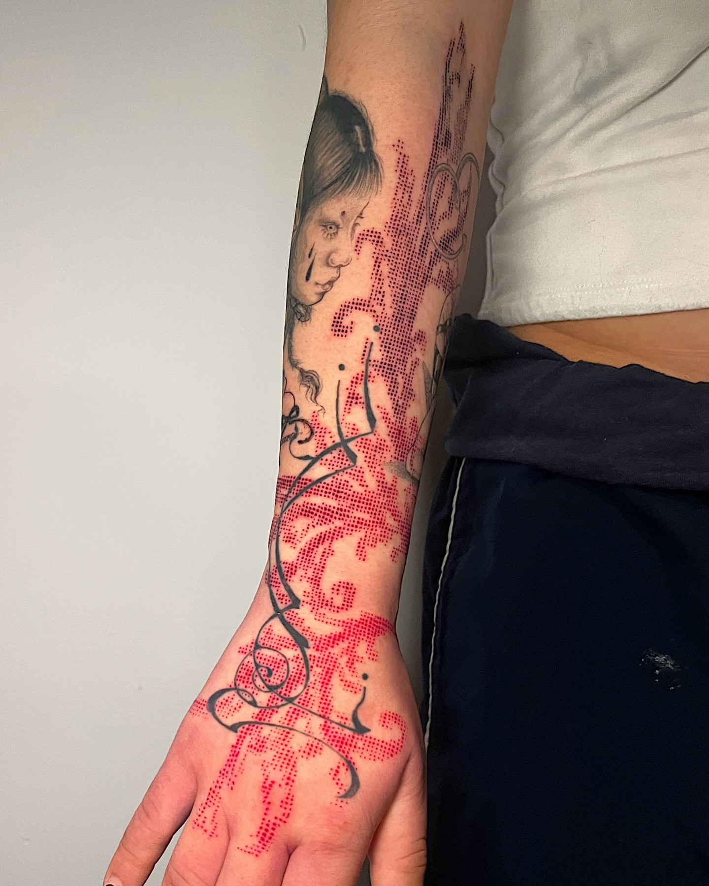 Portrait with floral elements dotwork tattoo on the forearm by Azucena
