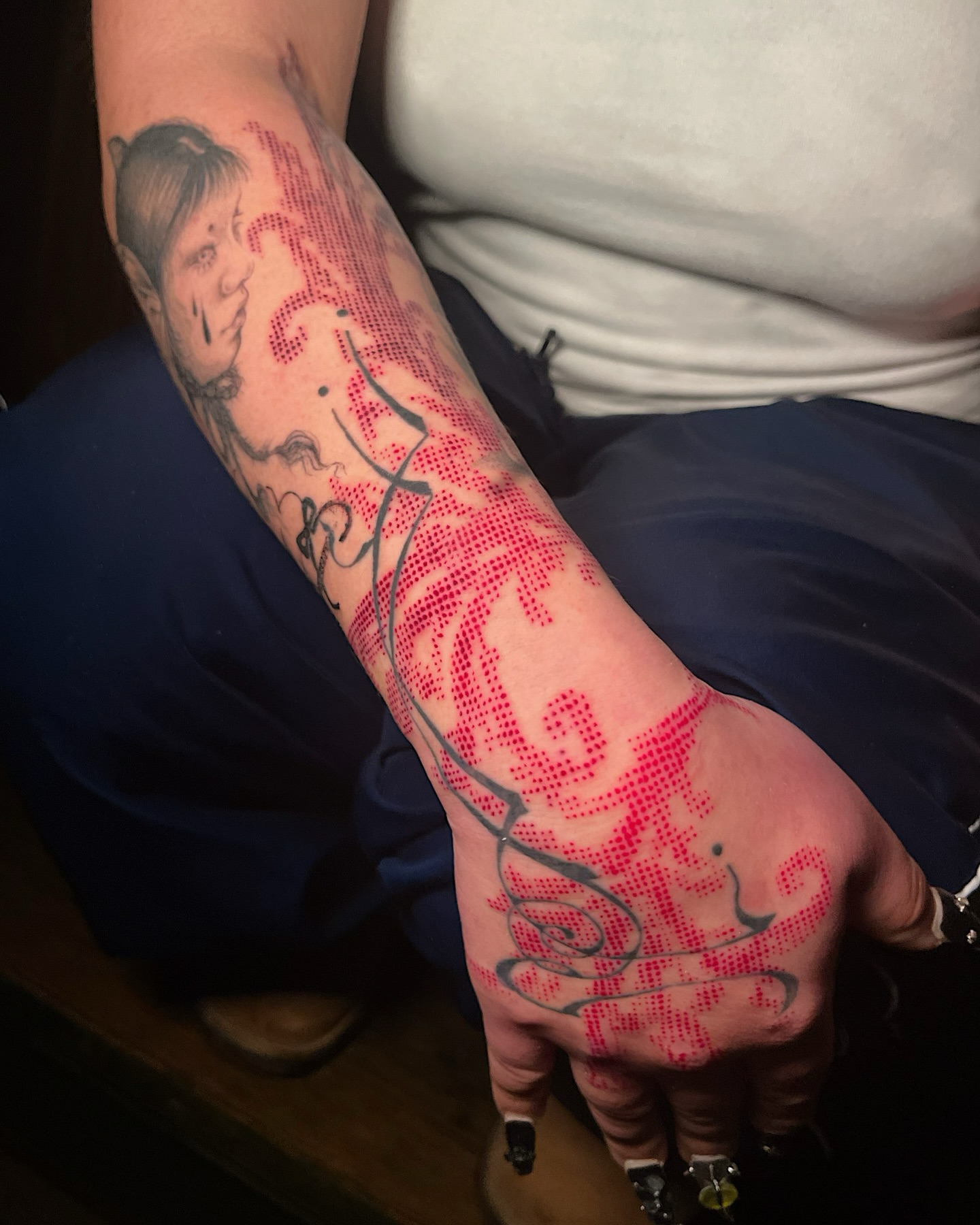 Portrait and floral dotwork tattoo on the forearm by Azucena