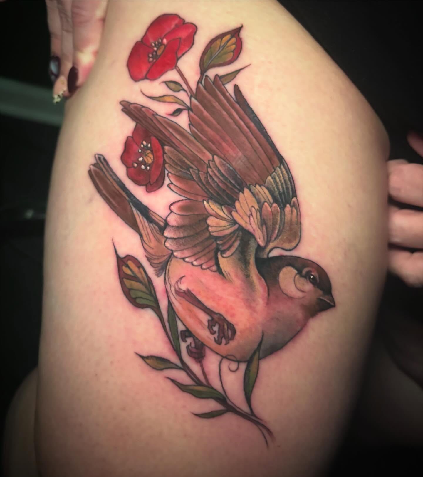 Bird and flowers realism tattoo on the thigh by Alle