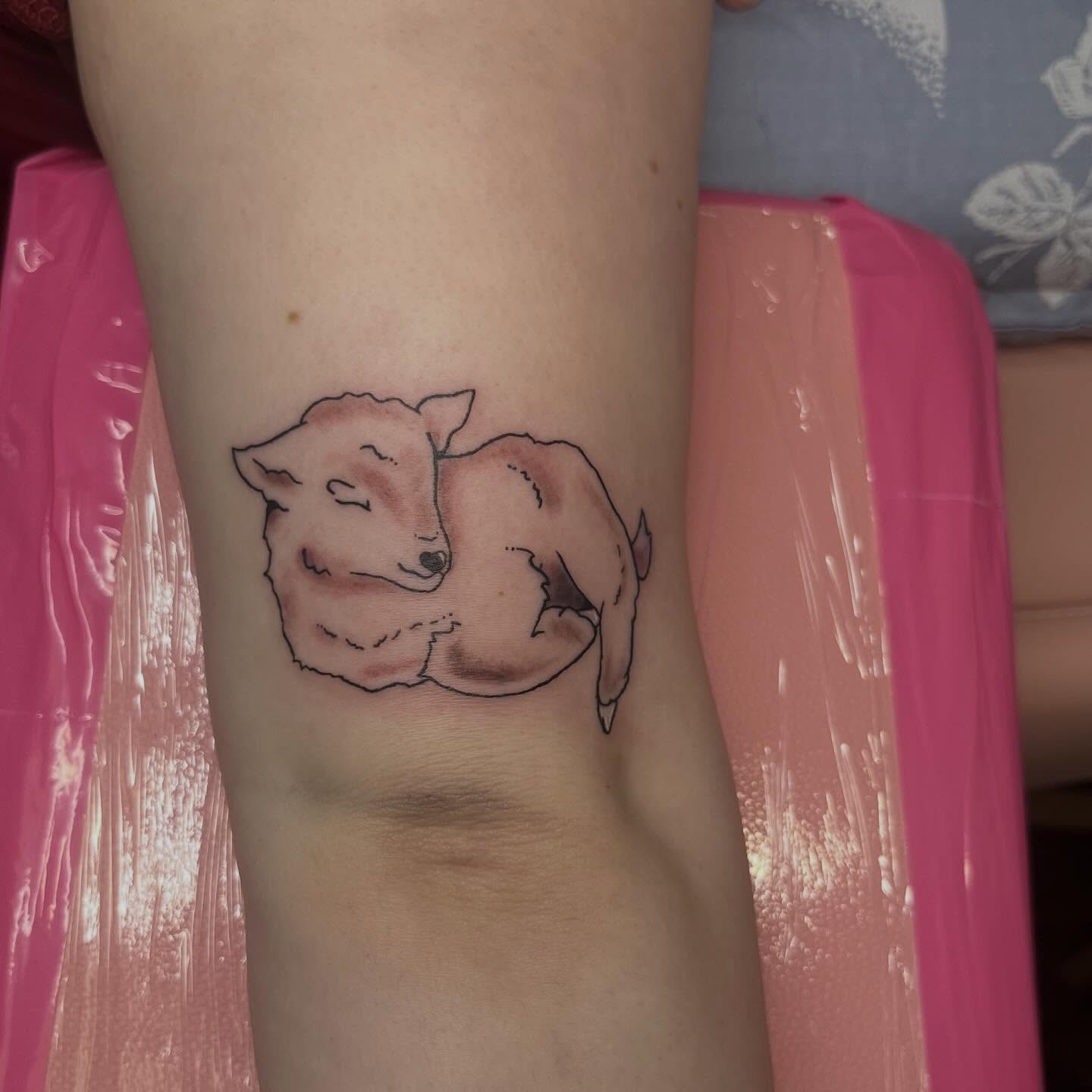 Sleeping lamb minimalist tattoo on the forearm by Jazzy