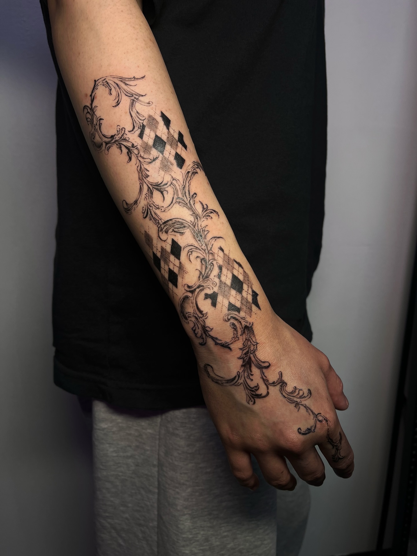 Diamond pattern with ornamental flourishes geometric tattoo on the forearm by MK