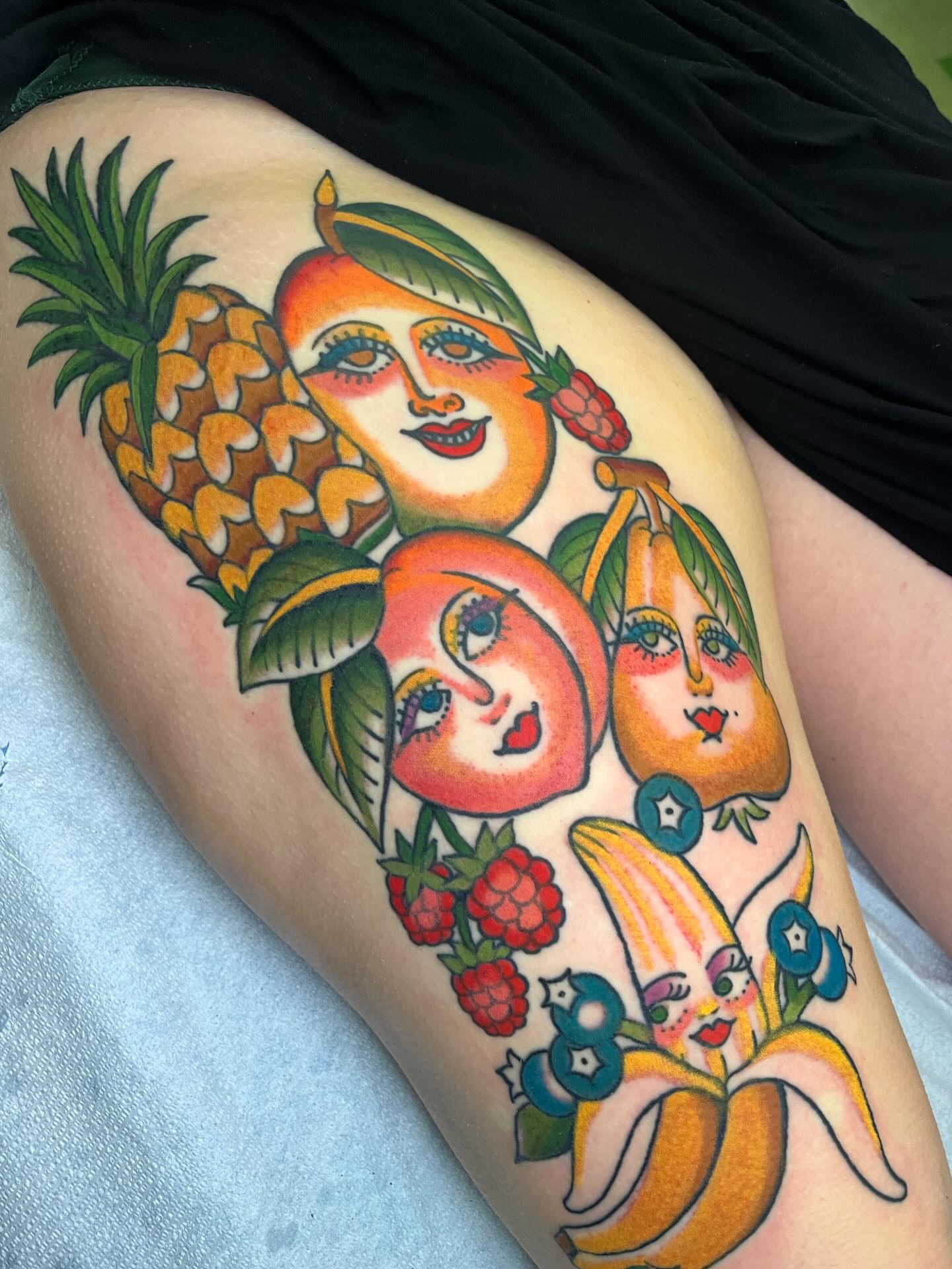 Fruit faces American traditional tattoo on the thigh by ⭐️ Erin Bauer ⭐️