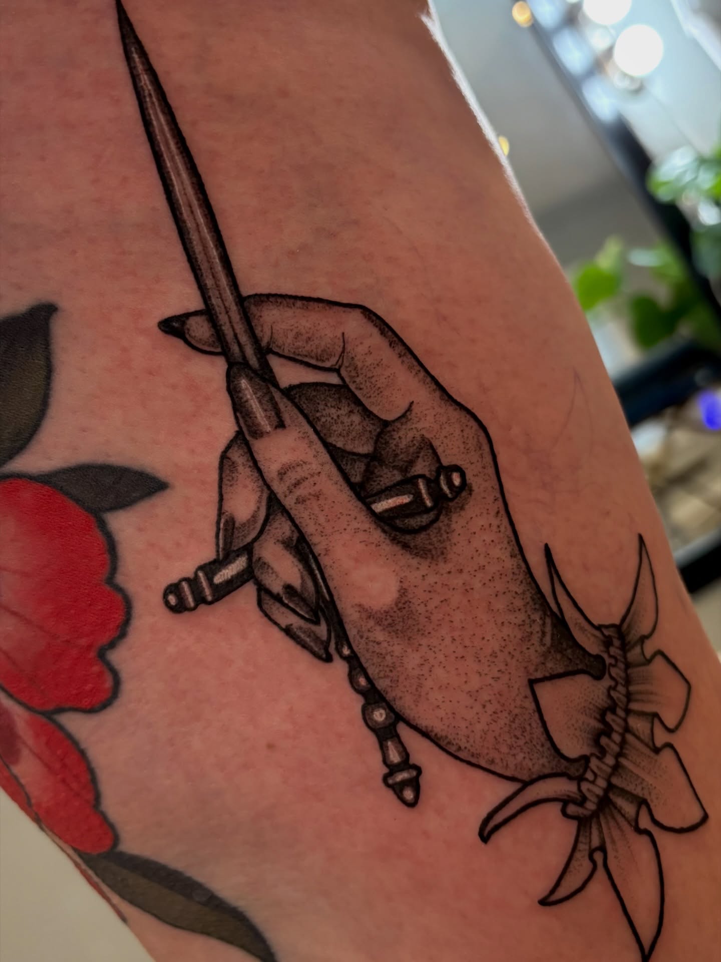 Hand holding dagger black and grey tattoo on the forearm by Tara, Exeter, Pennsylvania