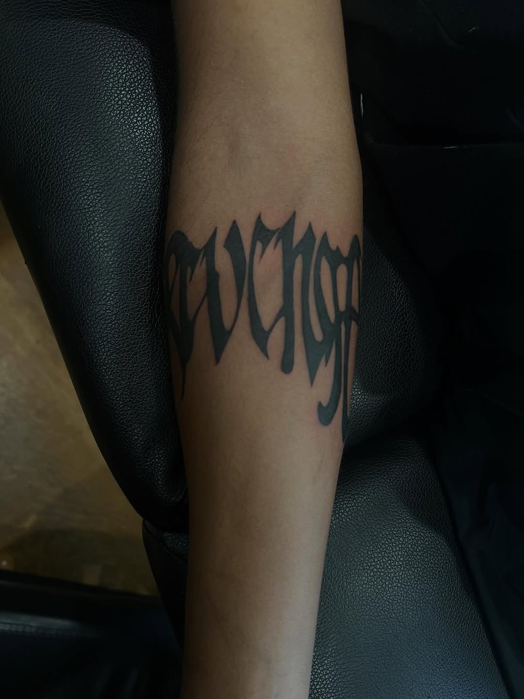 Revenge lettering lettering tattoo on the forearm by zion