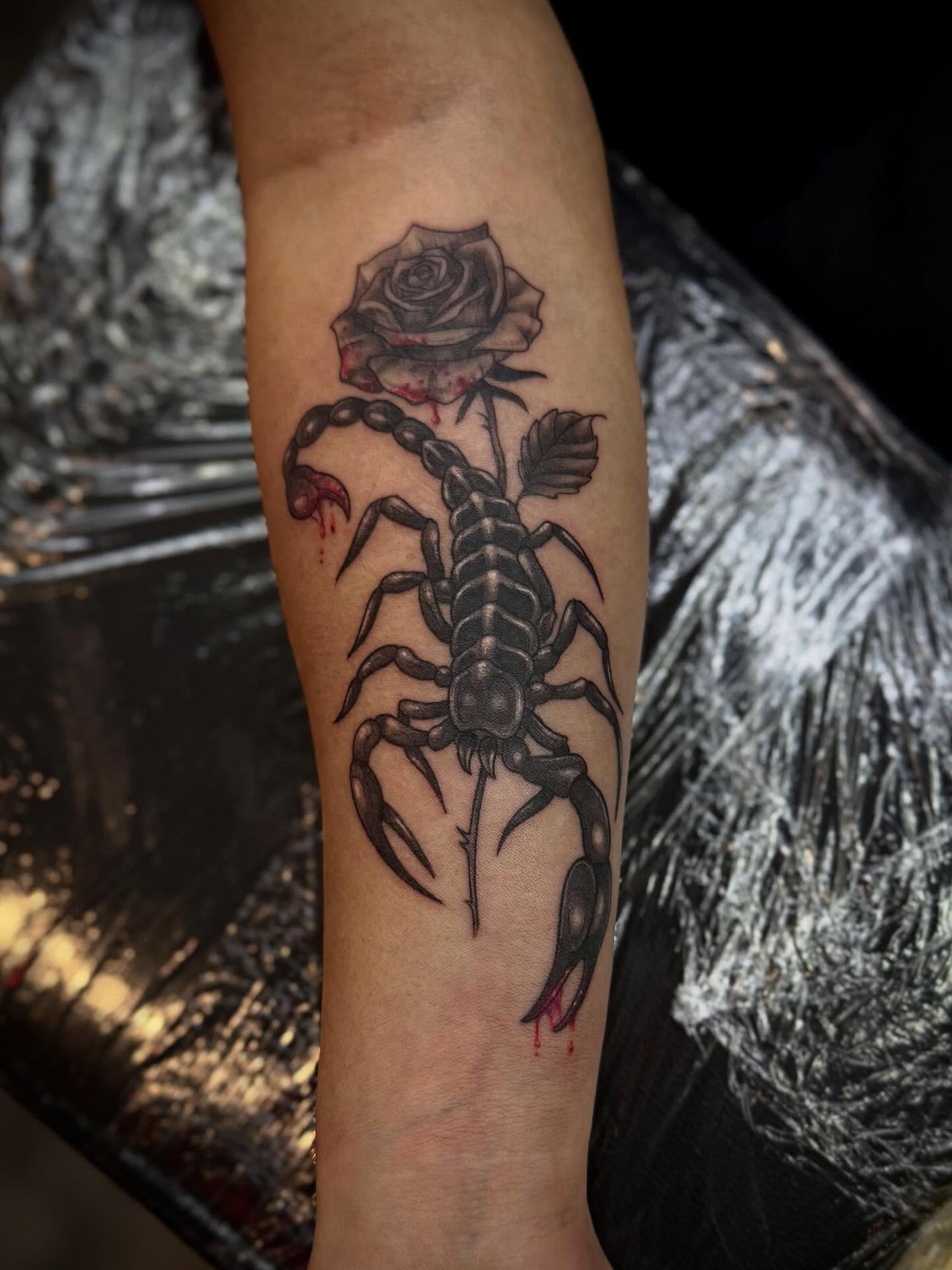 Scorpion and rose realism tattoo on the forearm by Ashley Kayser