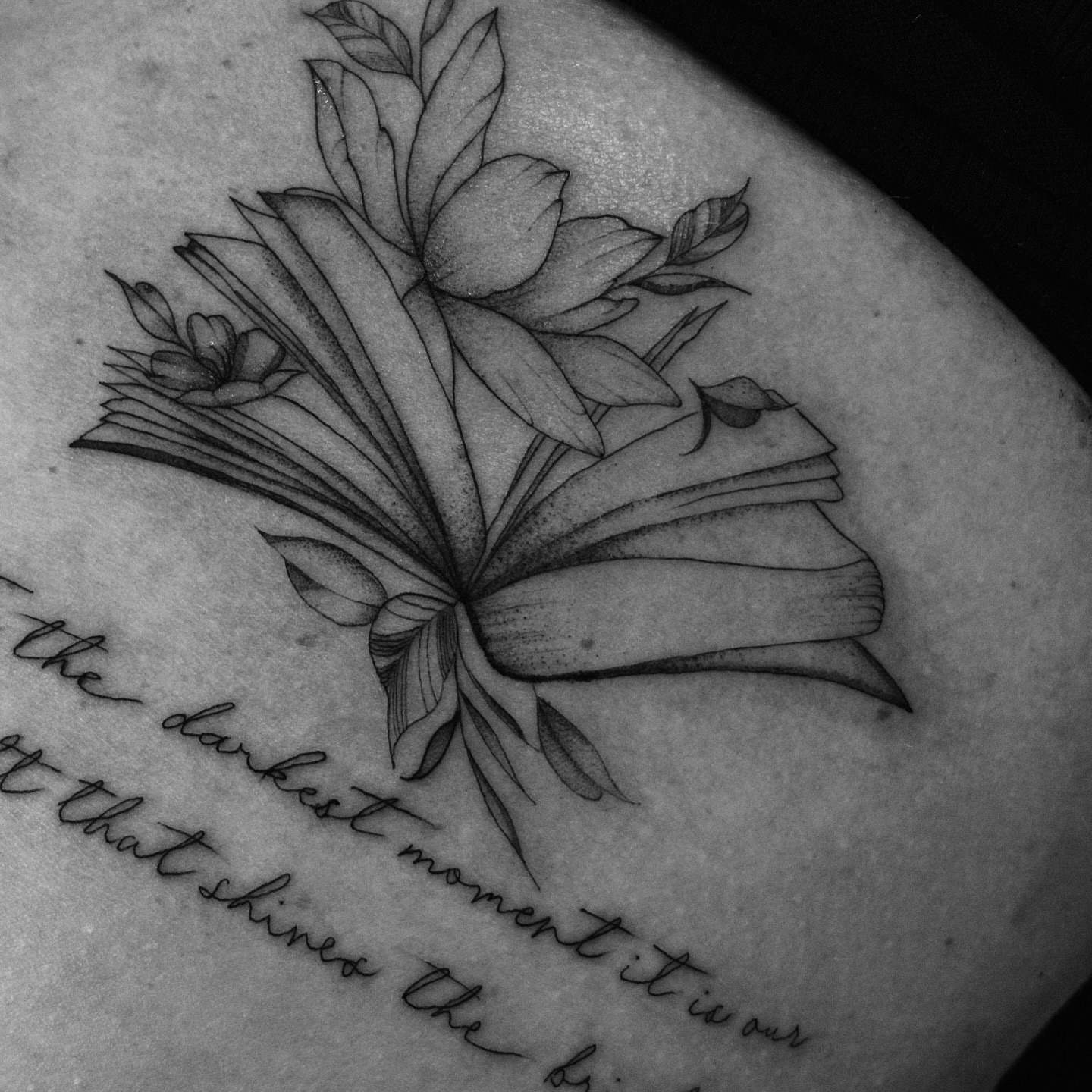 Book and flowers dotwork tattoo on the upper arm by Tayler, Tooele, Utah