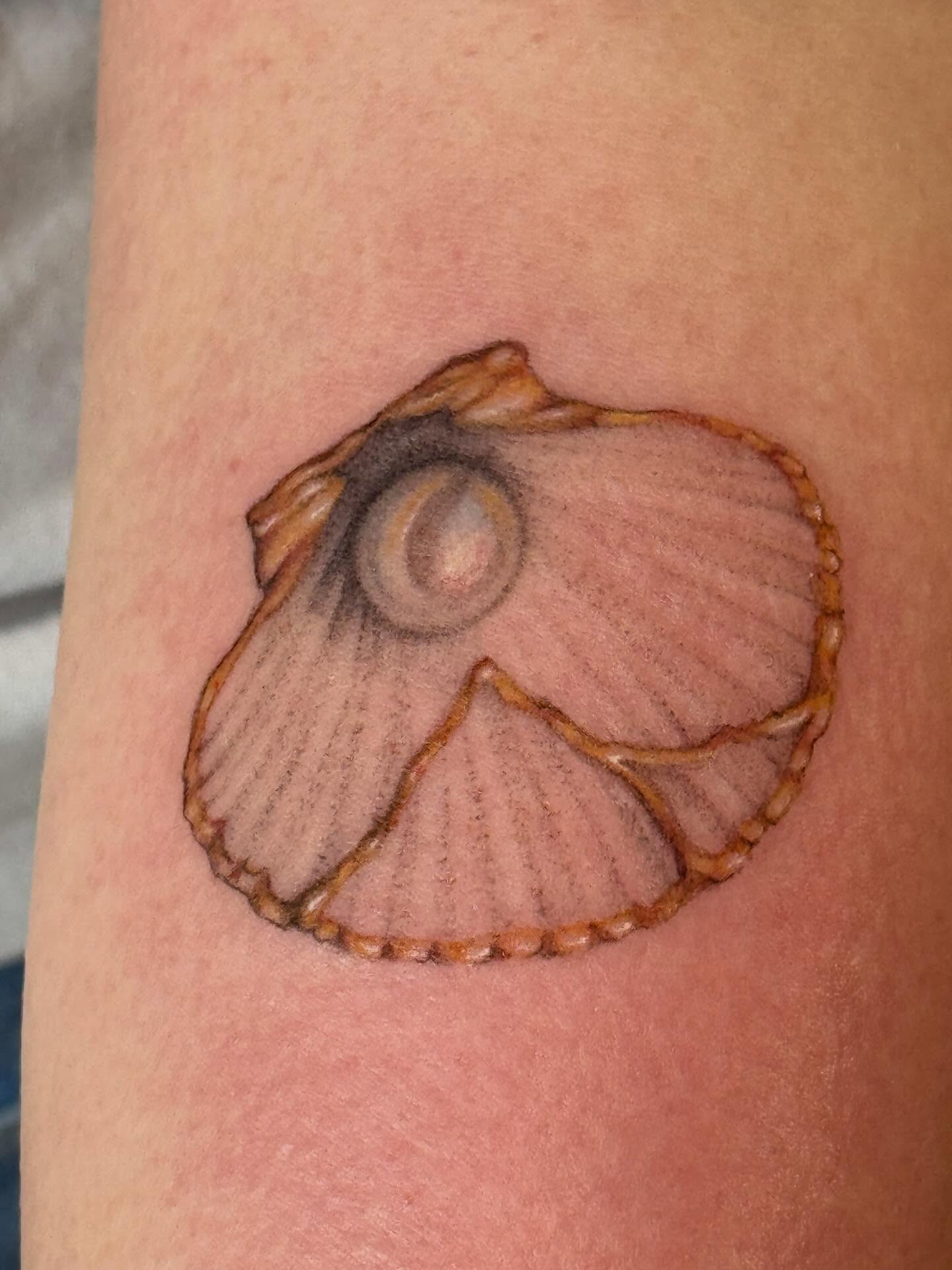 Nautilus shell realism tattoo on the forearm by Sarah Seveney