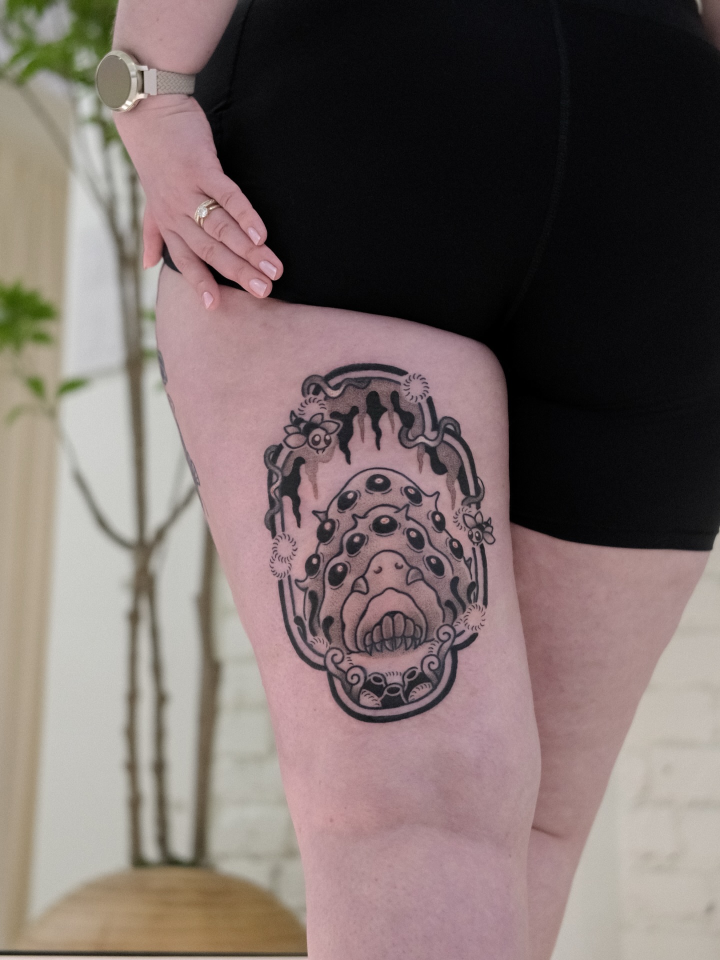 Mask black and grey tattoo on the thigh by seattle tattoo artist