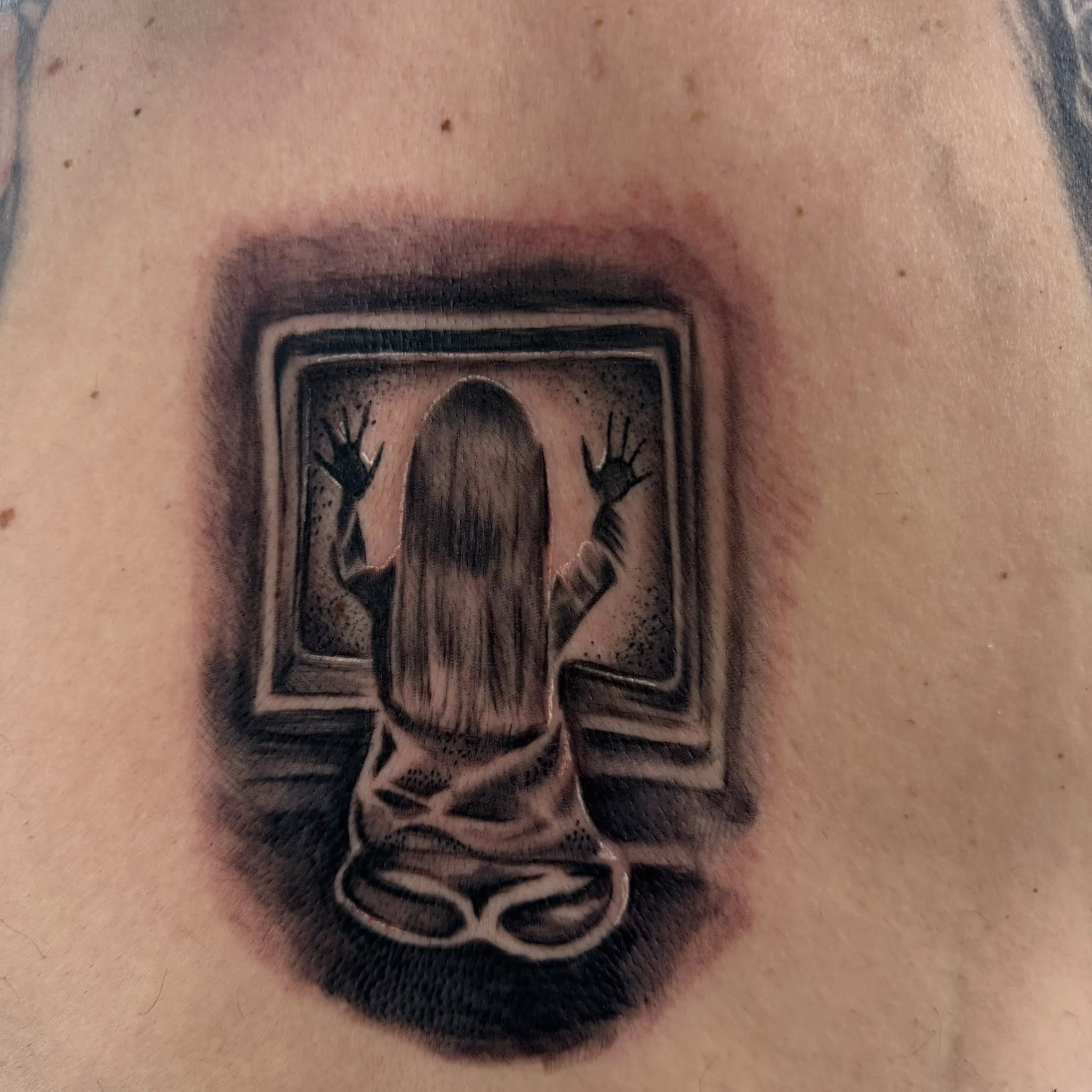 Ghostly figure realism tattoo on the chest by Haley Winfree
