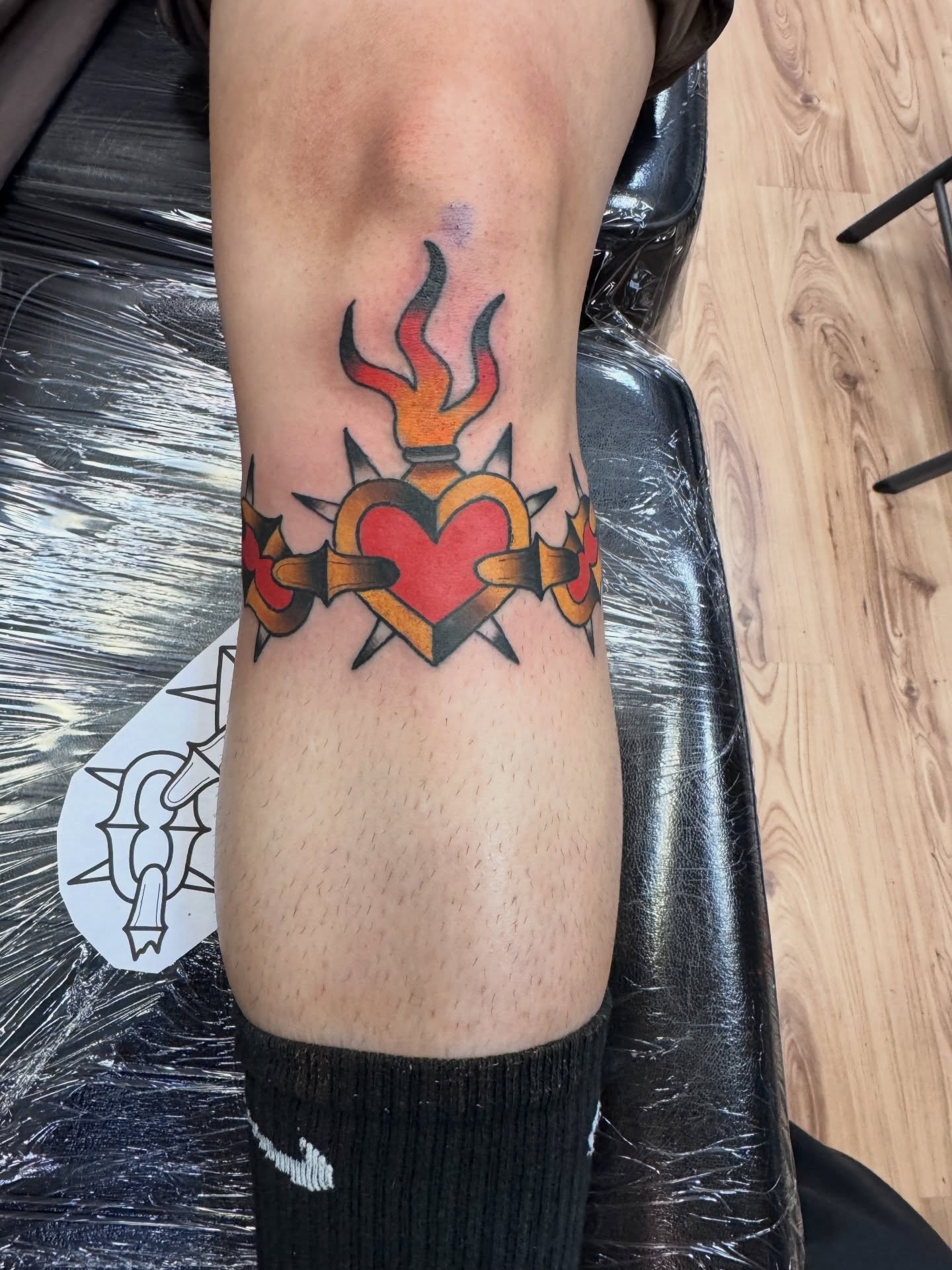 Heart with flames American traditional tattoo on the forearm by Justin Chapman, Des Moines, Iowa