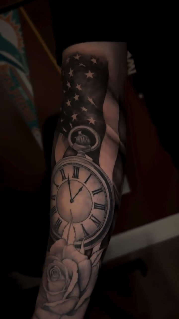 Clock and rose with American flag realism tattoo by Tiago Britto
