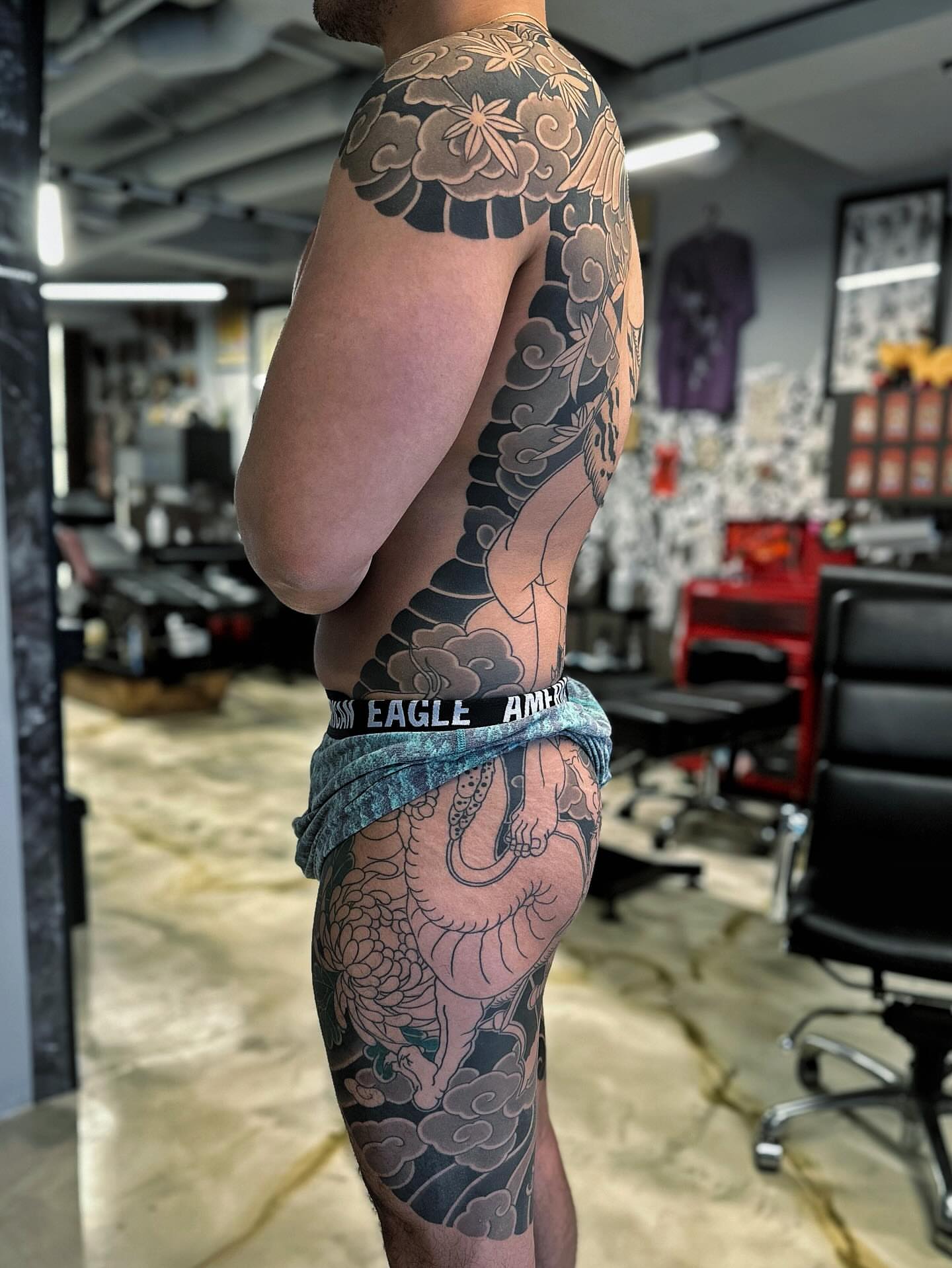 Dragon and clouds japanese irezumi tattoo on the upper arm by Xiaojun Yin, Vancouver, British Columbia