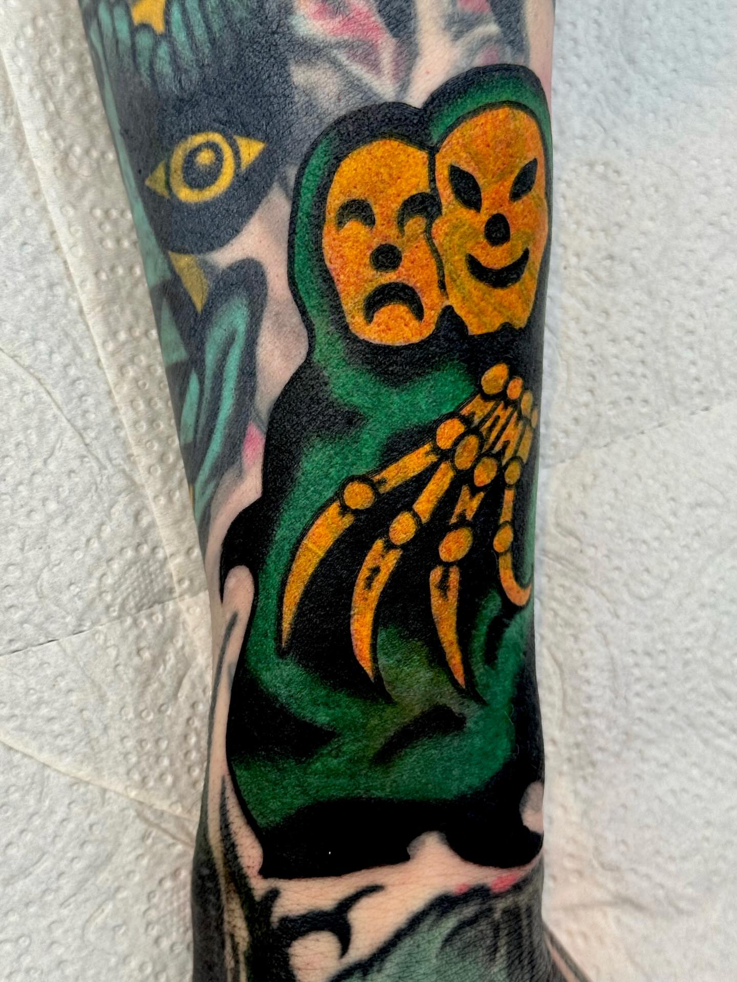 Theater masks American traditional tattoo on the forearm by JAX