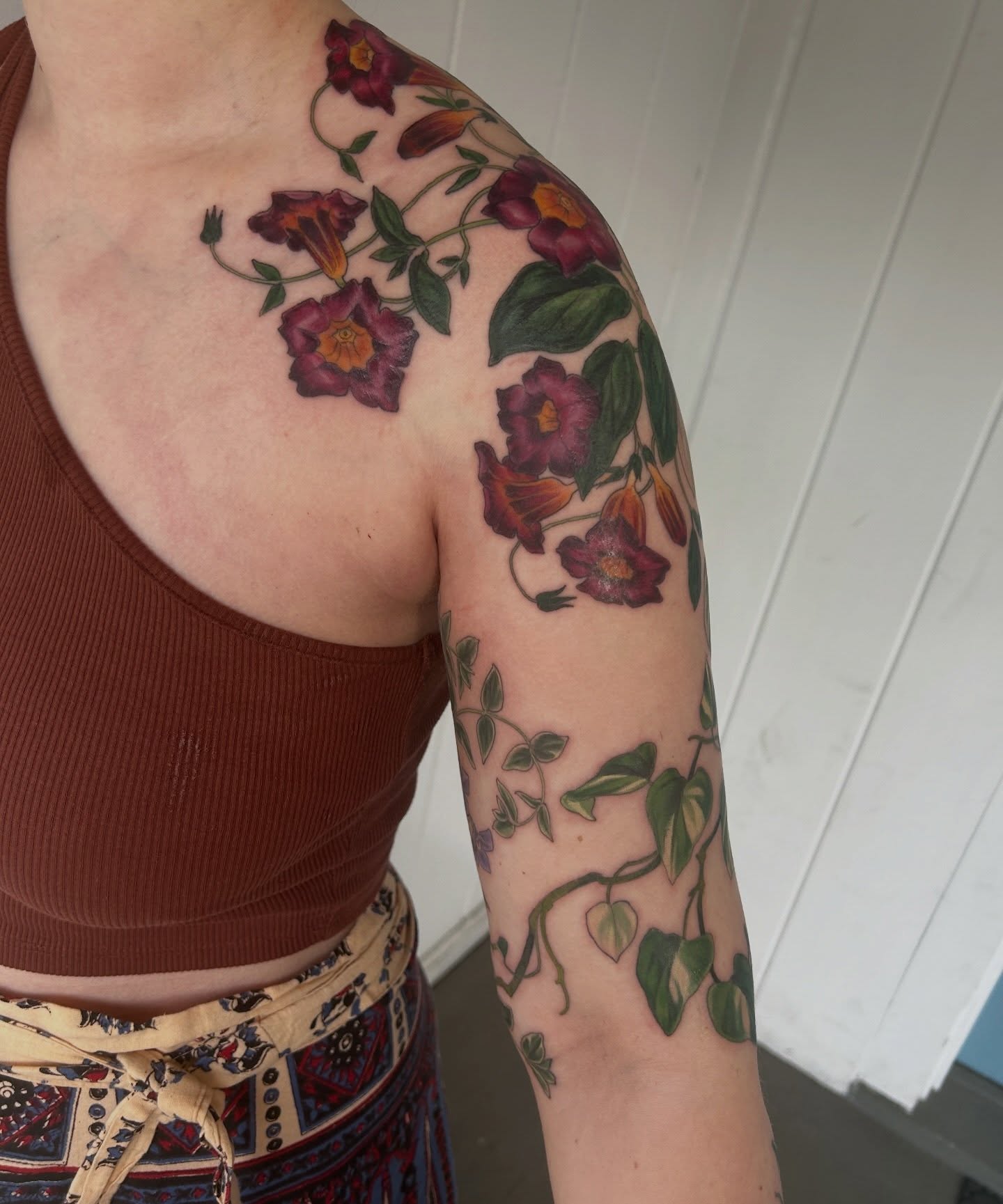 Bell flowers realism tattoo on the upper arm by Anna Sylvan Tattoos