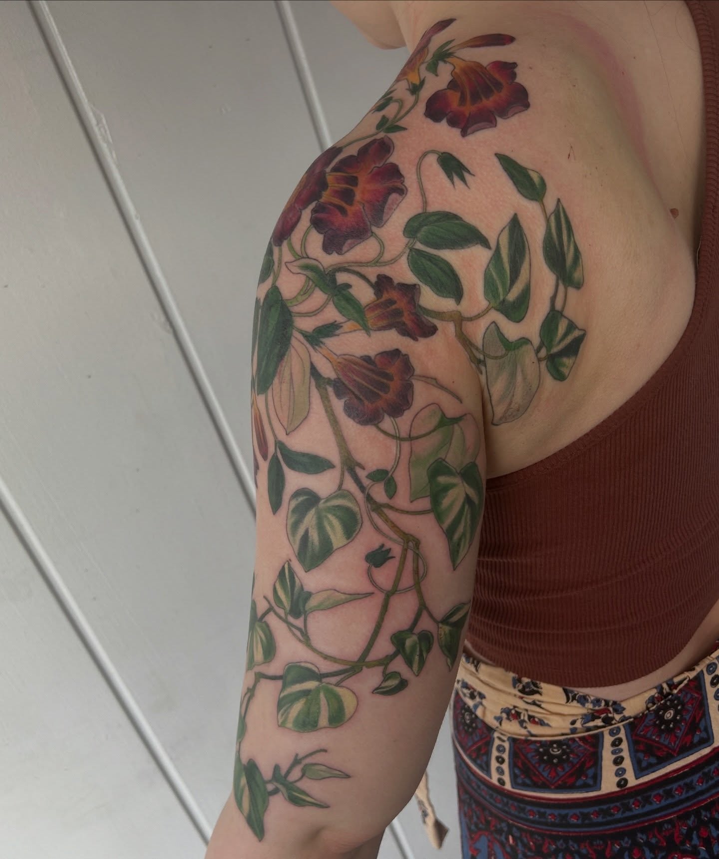 Morning glory vines realism tattoo on the upper arm by Anna Sylvan Tattoos