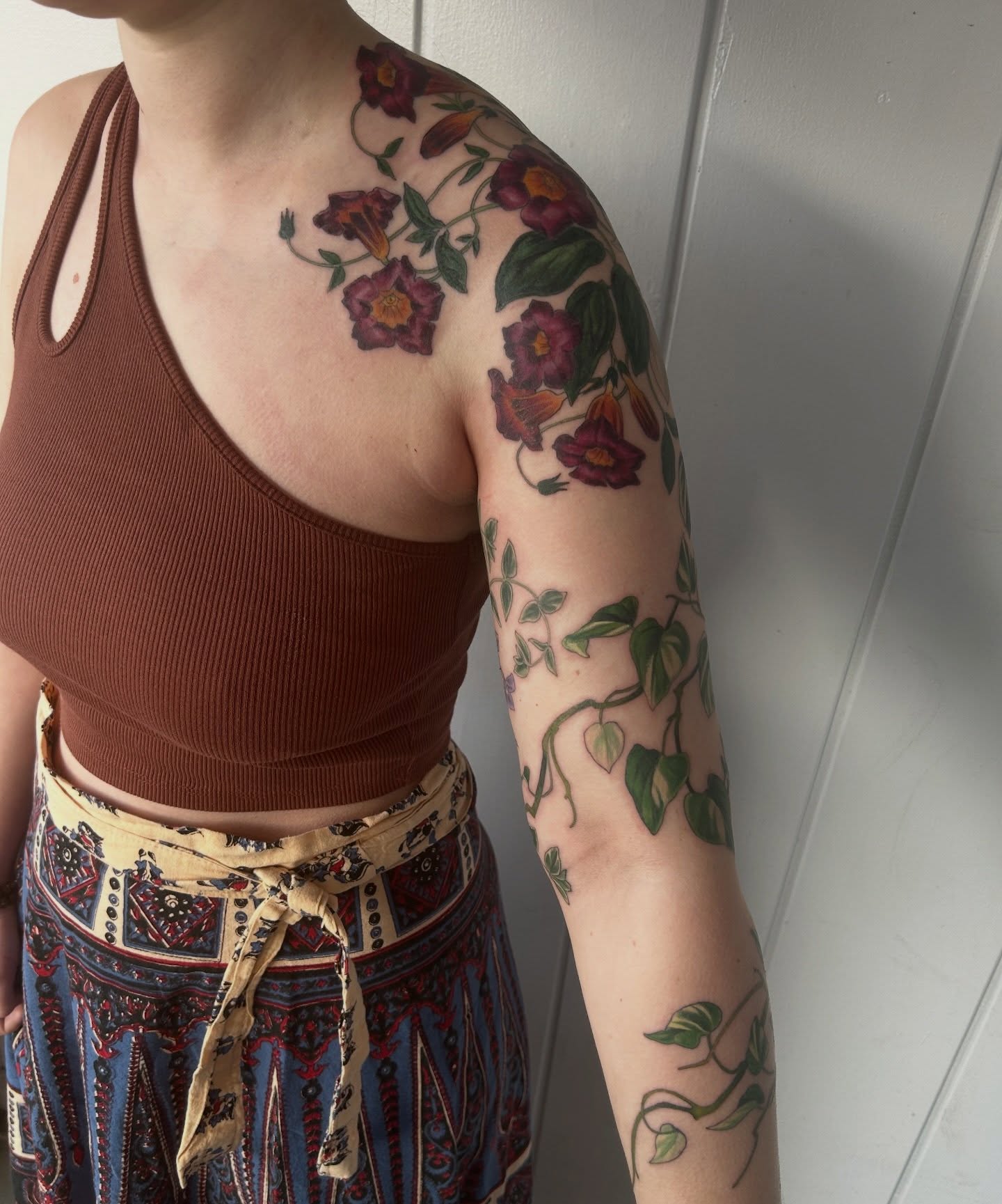 Floral vine realism tattoo on the upper arm by Anna Sylvan Tattoos