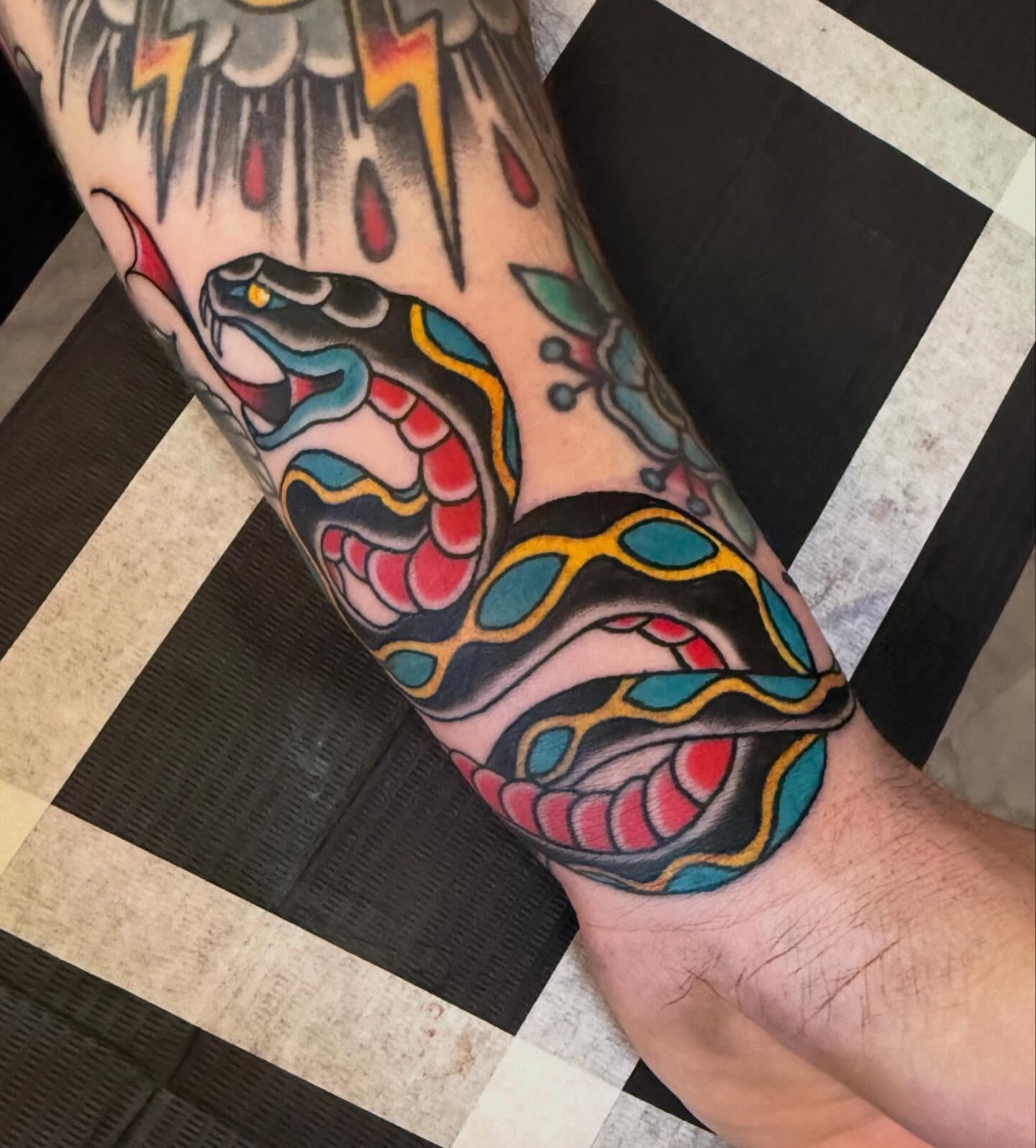 Snake American traditional tattoo on the forearm by Kyle Behr