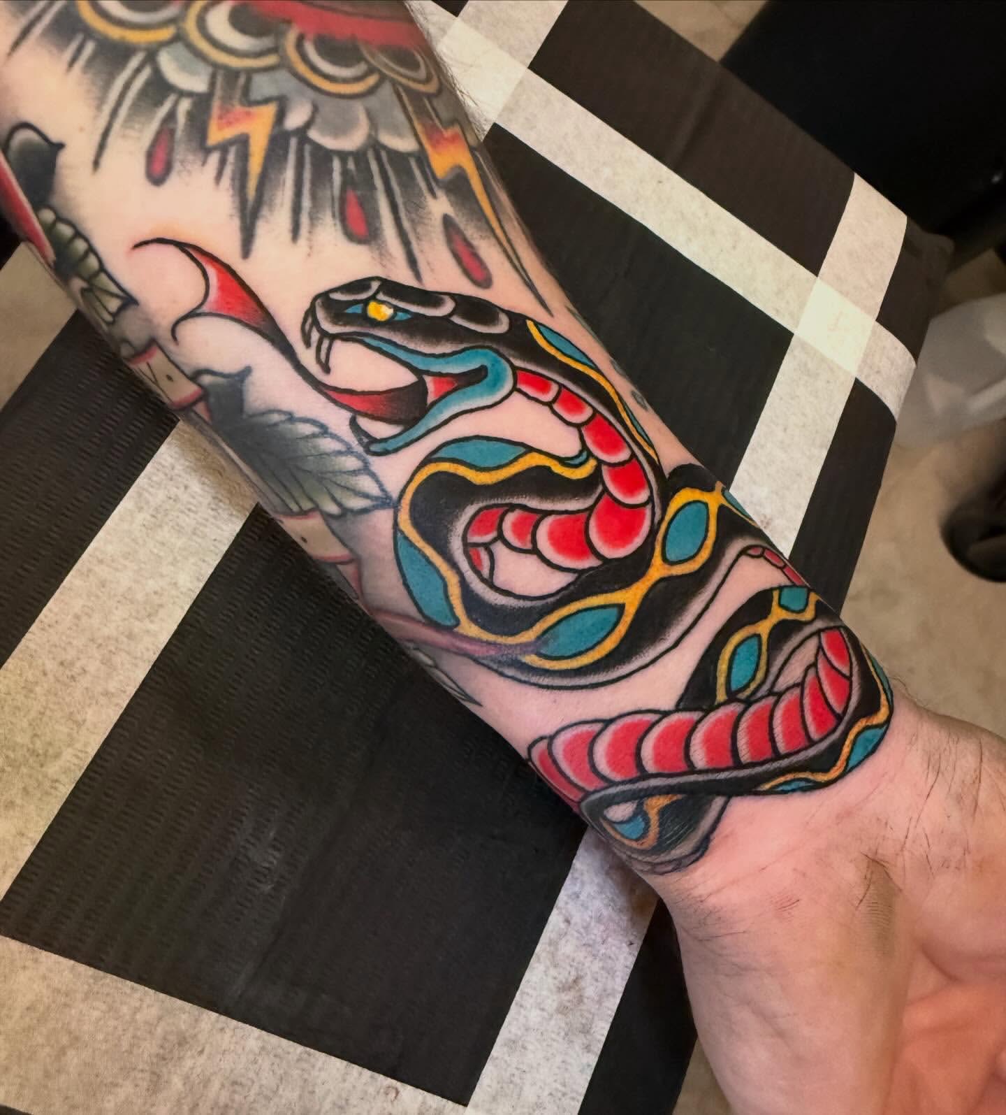 Snake American traditional tattoo on the forearm by Kyle Behr