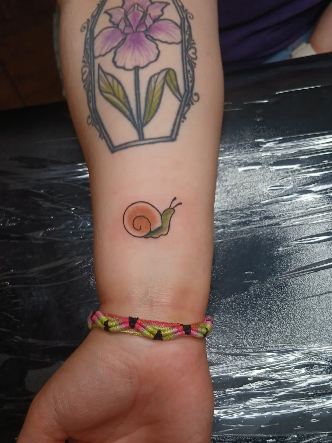 Snail new school tattoo on the forearm by Amber Tattoos