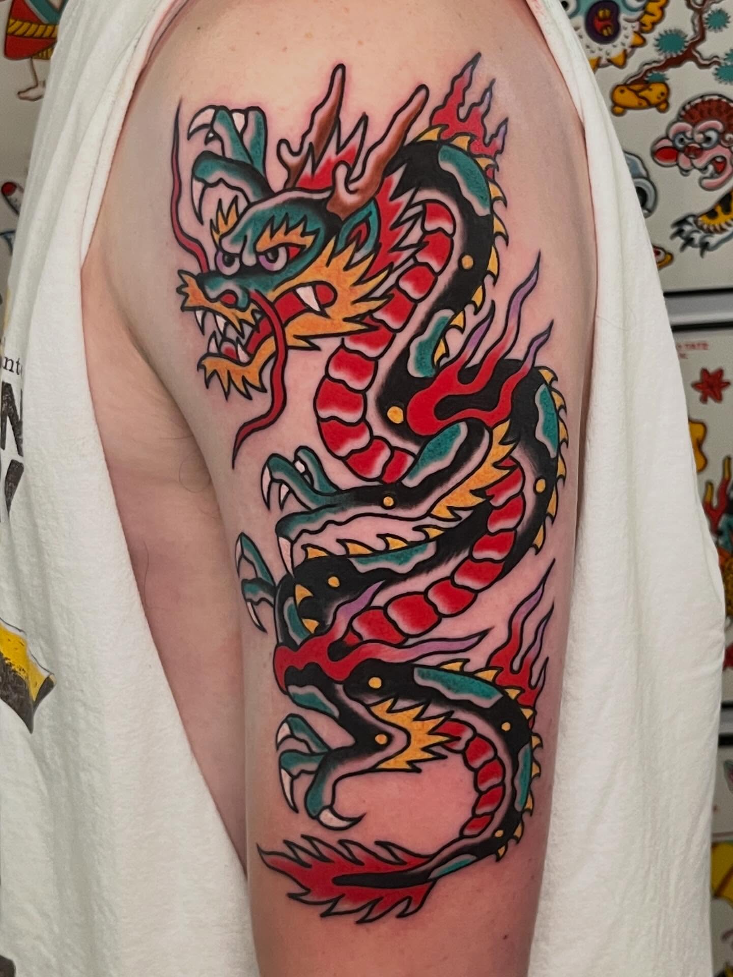 Dragon American traditional tattoo on the upper arm by Rizzo