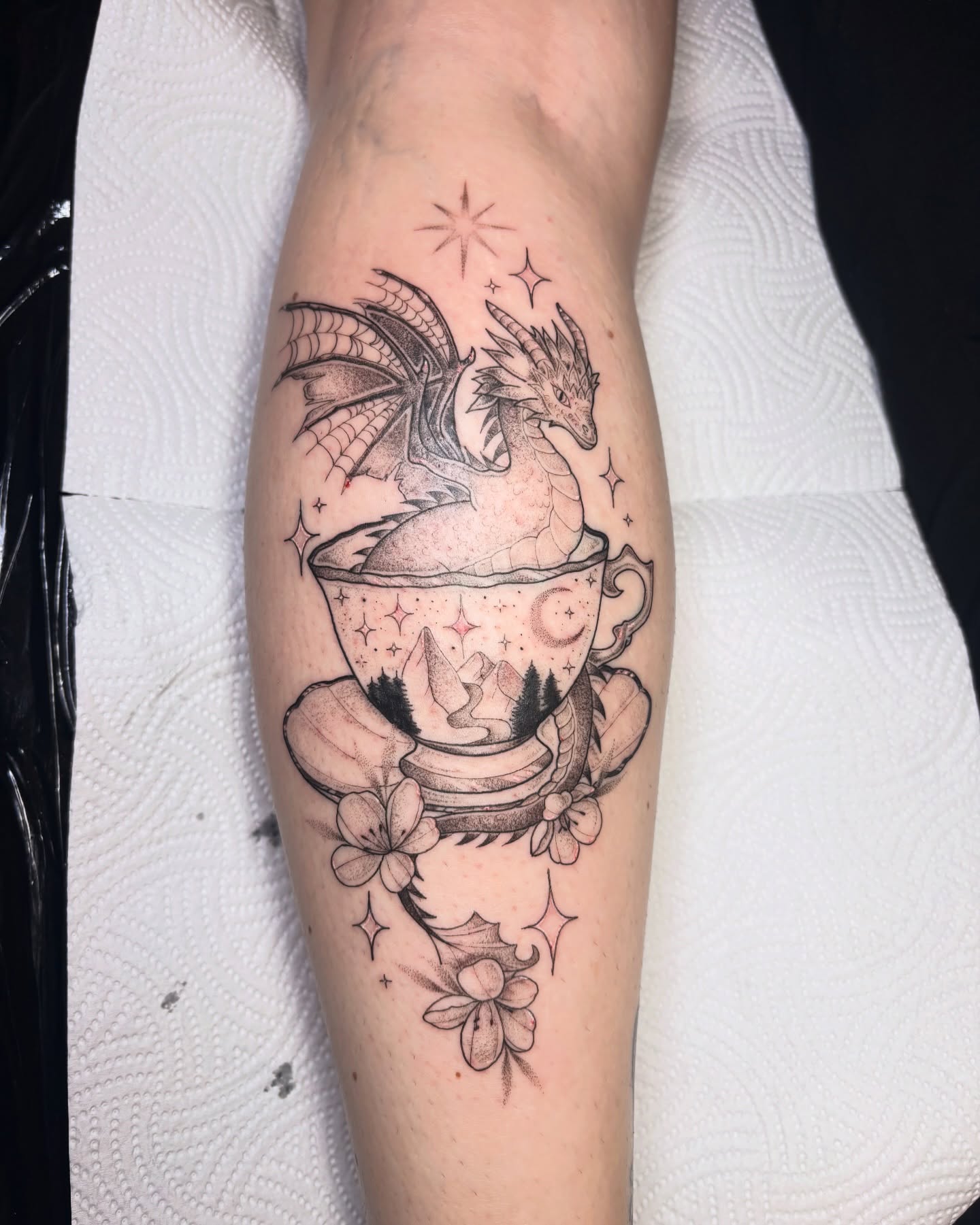 Dragon in teacup realism tattoo on the forearm by Charlotte Brown, Leeds, England